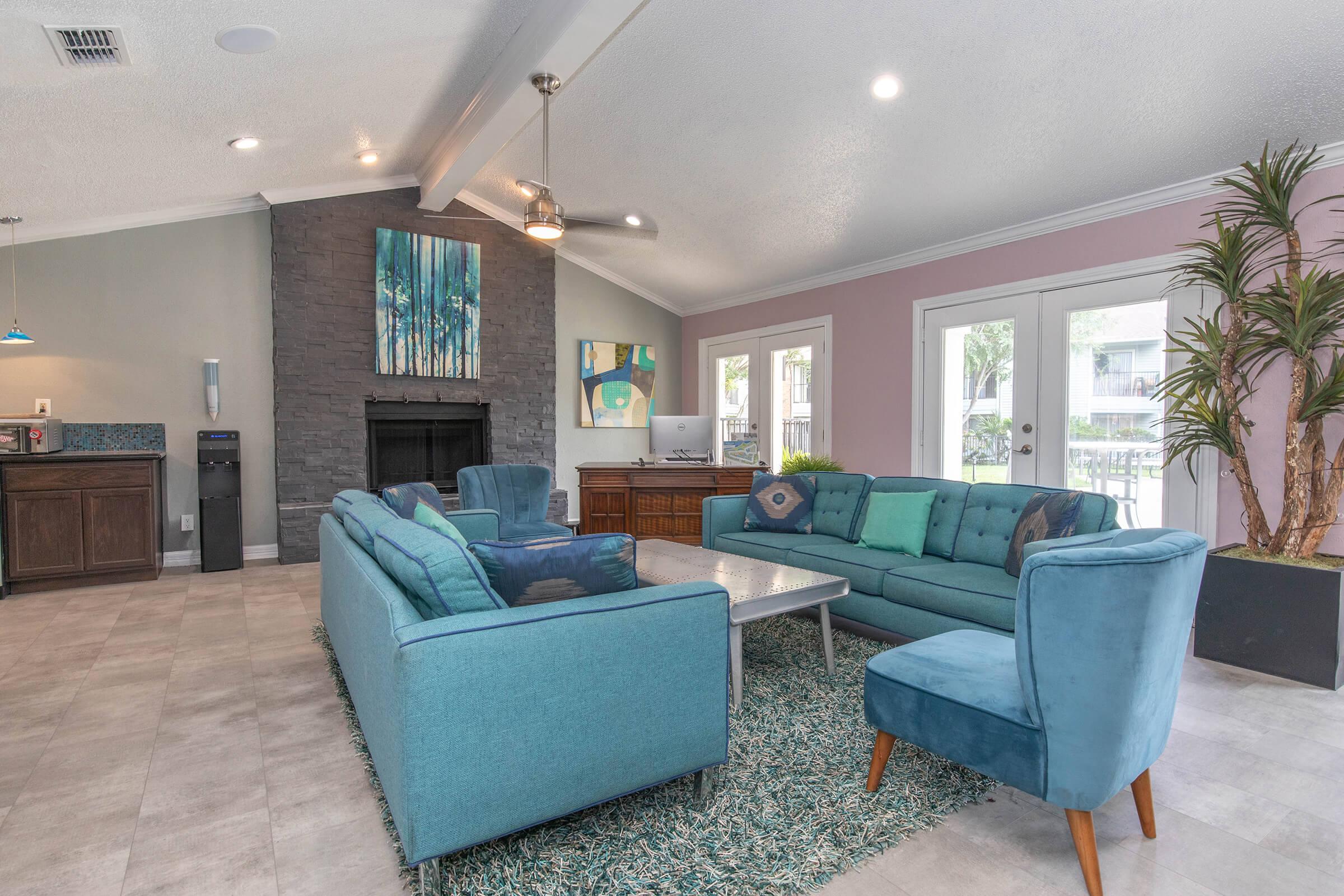 a living room filled with furniture and a large window