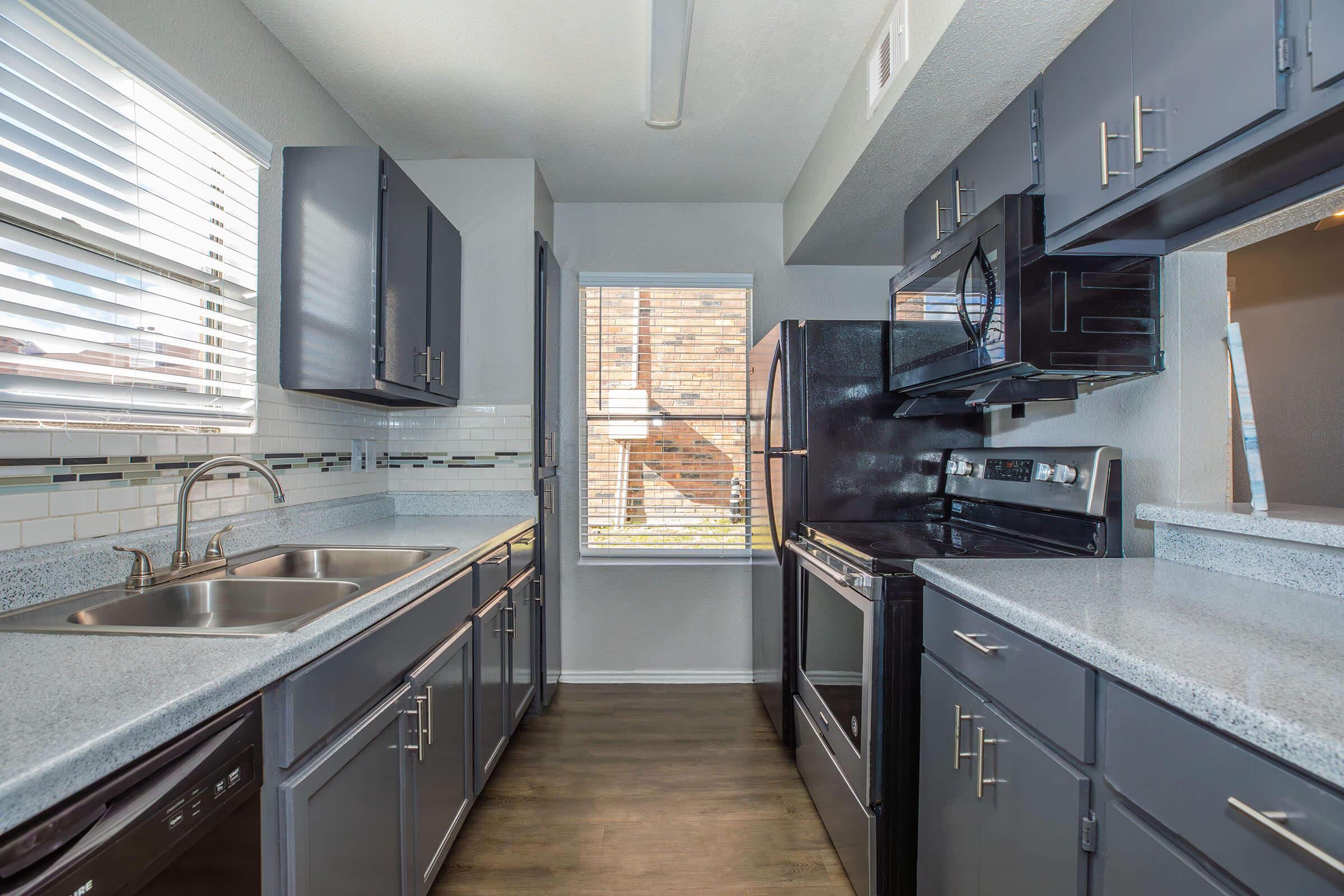 a large kitchen with stainless steel appliances