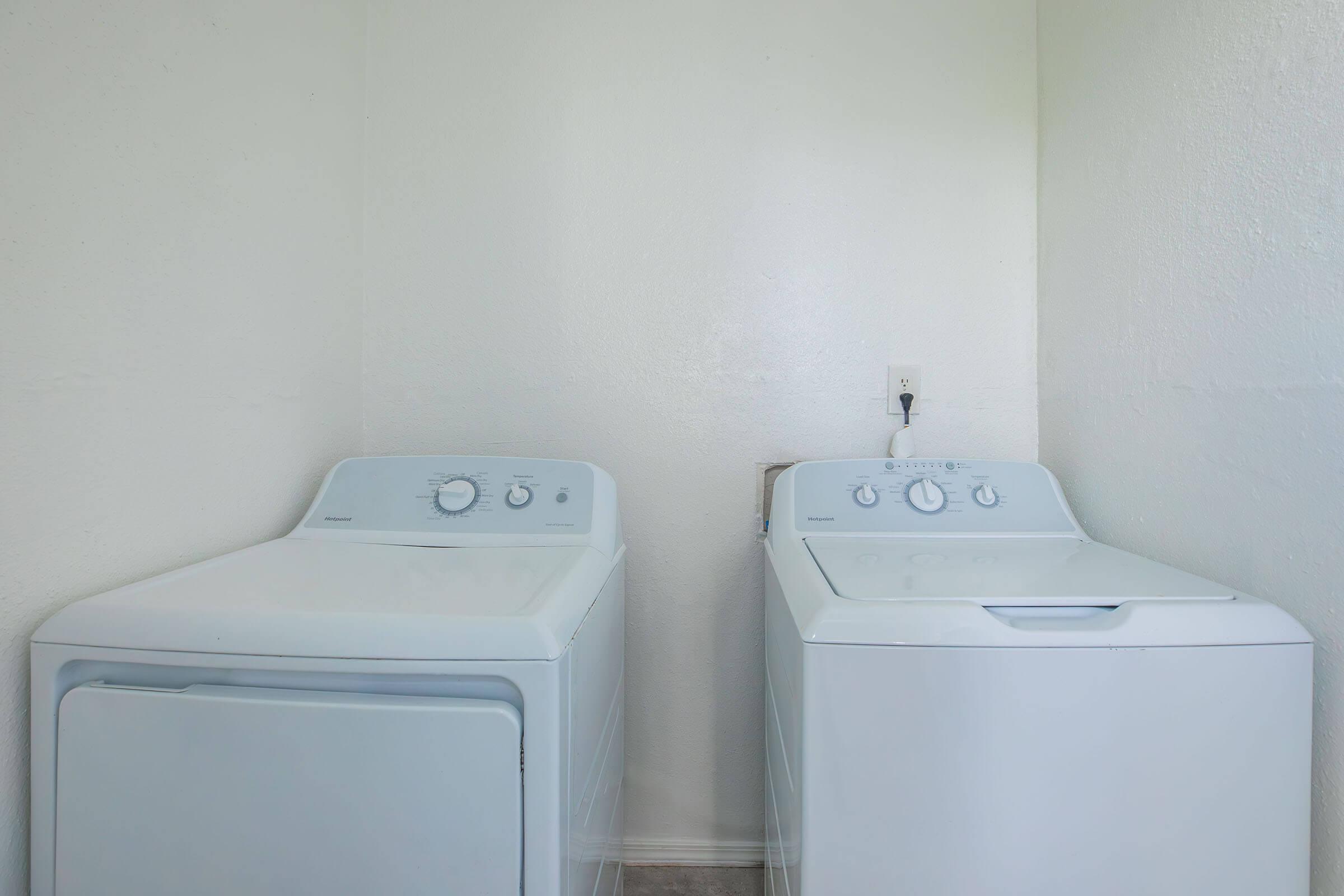 a microwave oven sitting on top of a refrigerator