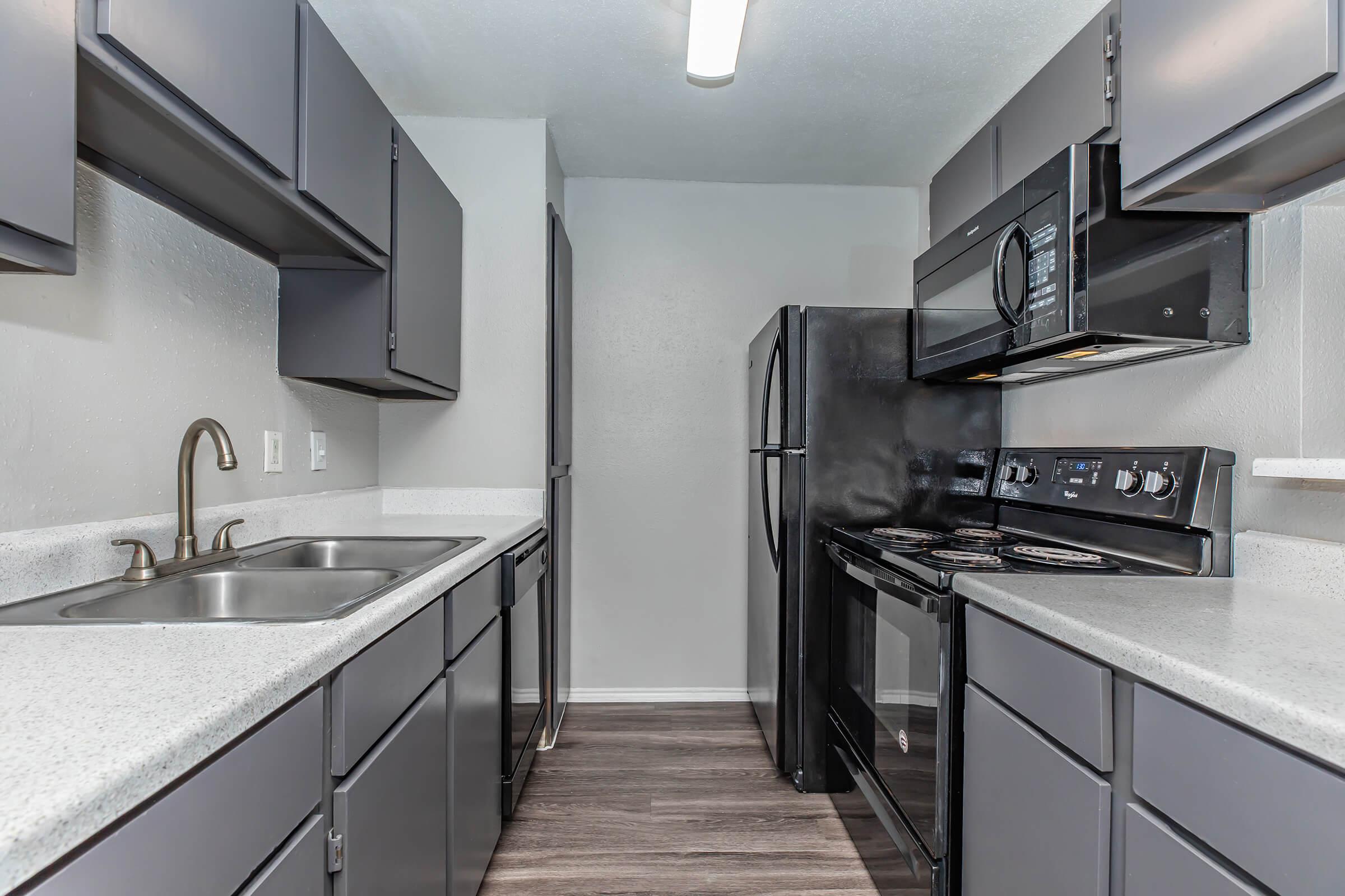 a kitchen with a stainless steel sink