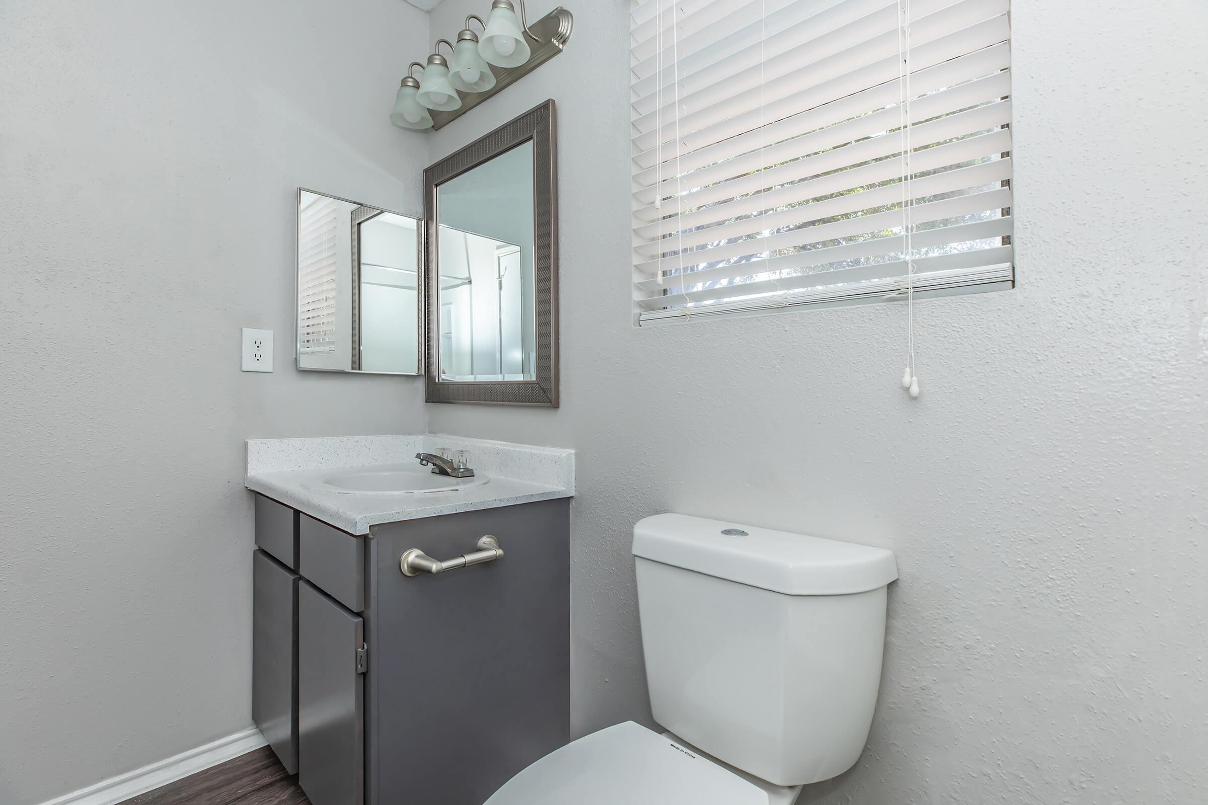 a room with a sink and a mirror