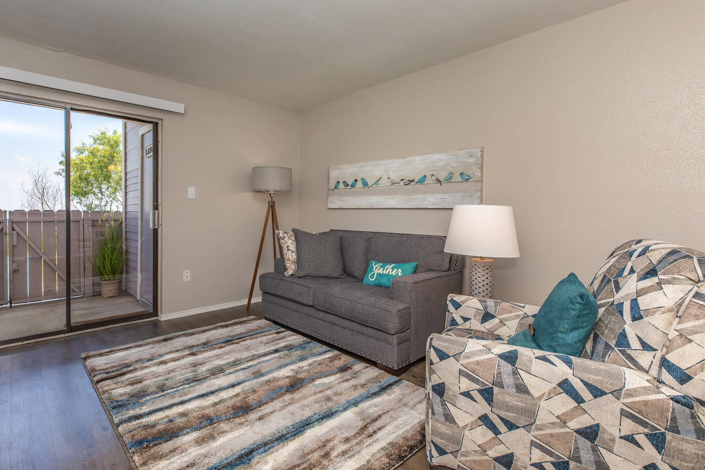 a living room with a bed and a window