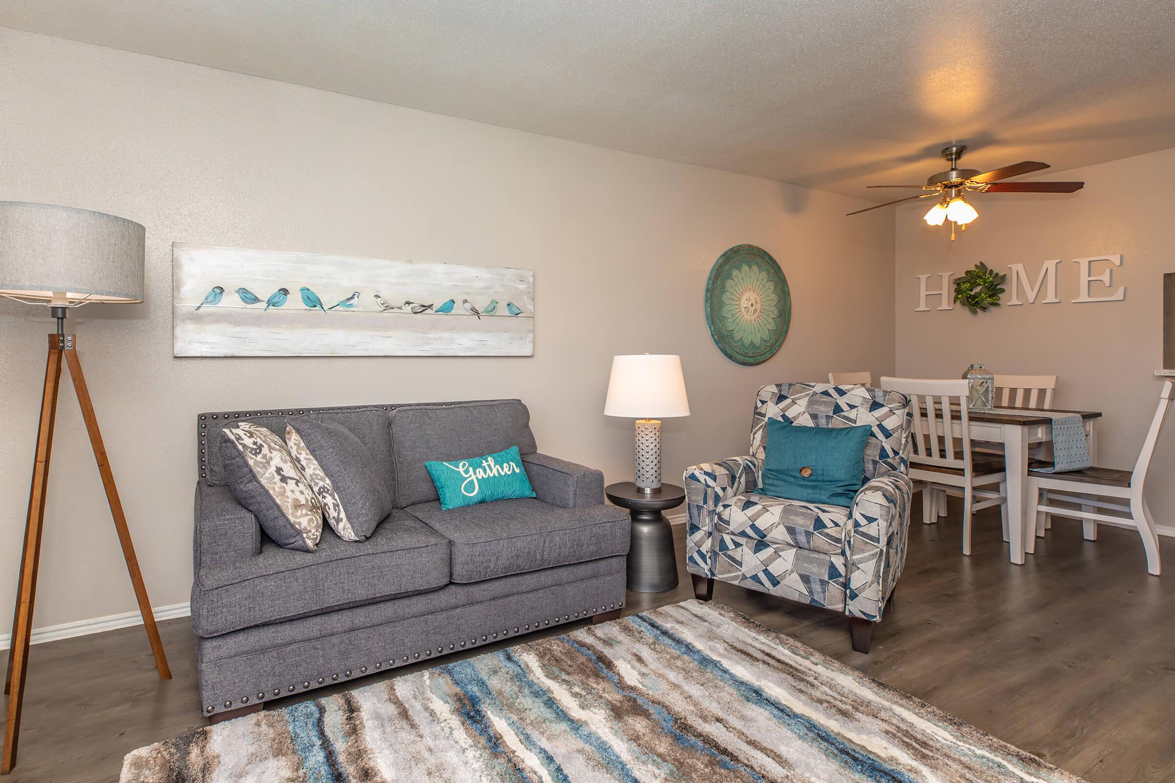 a living room filled with furniture and a flat screen tv