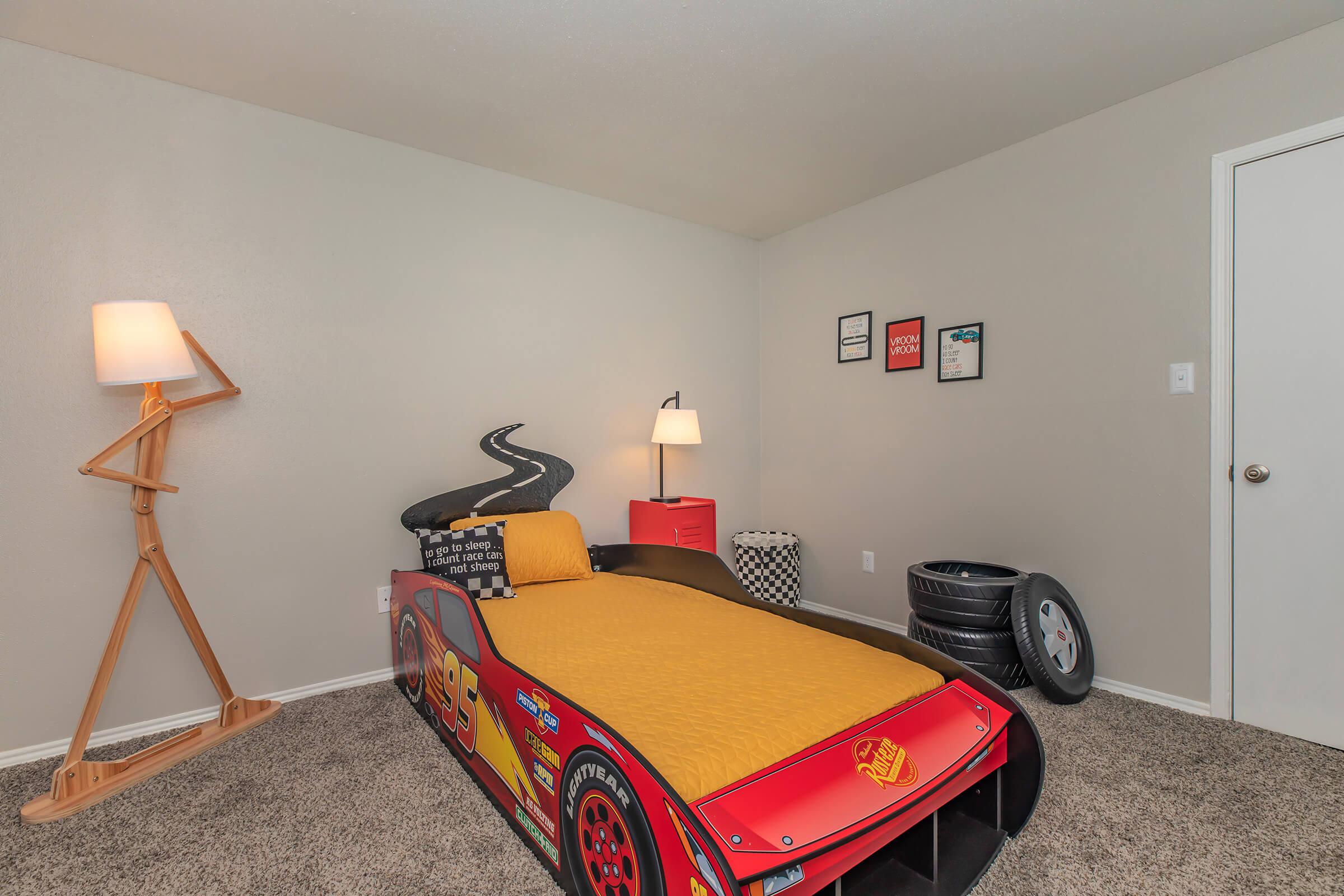 a bedroom with a bed and desk in a room