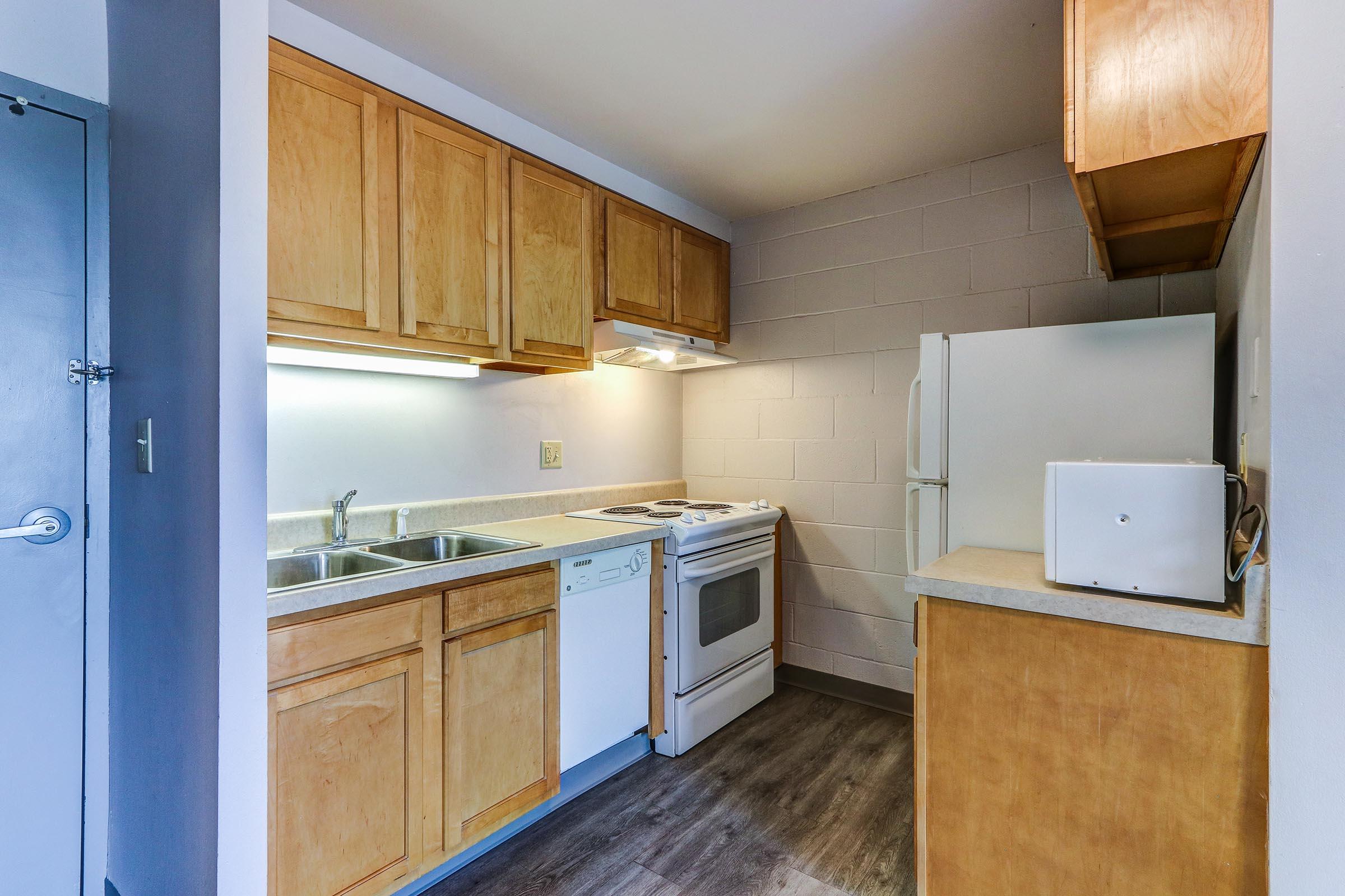 a kitchen with a stove and a refrigerator