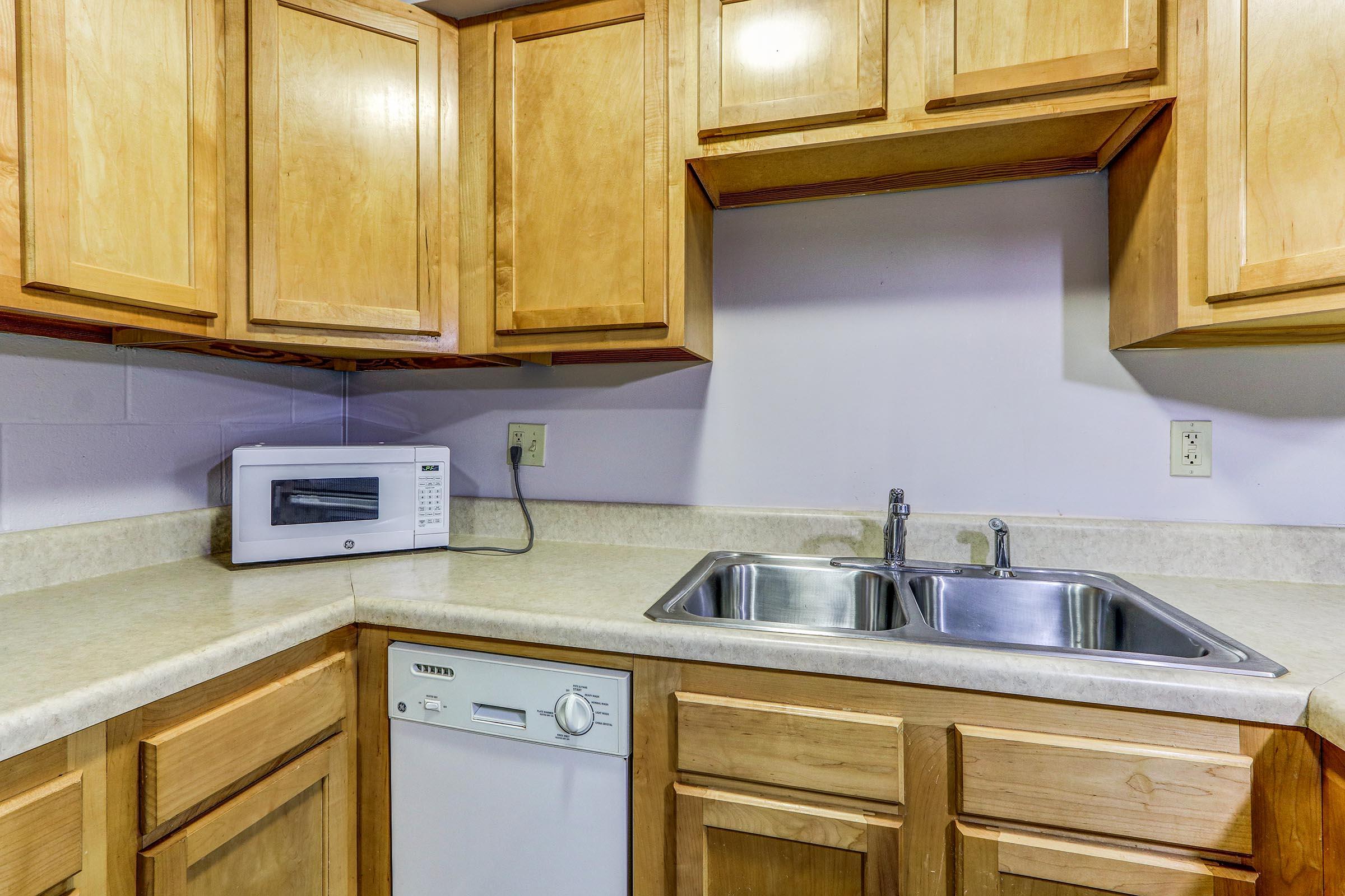 a kitchen with stainless steel appliances and wooden cabinets