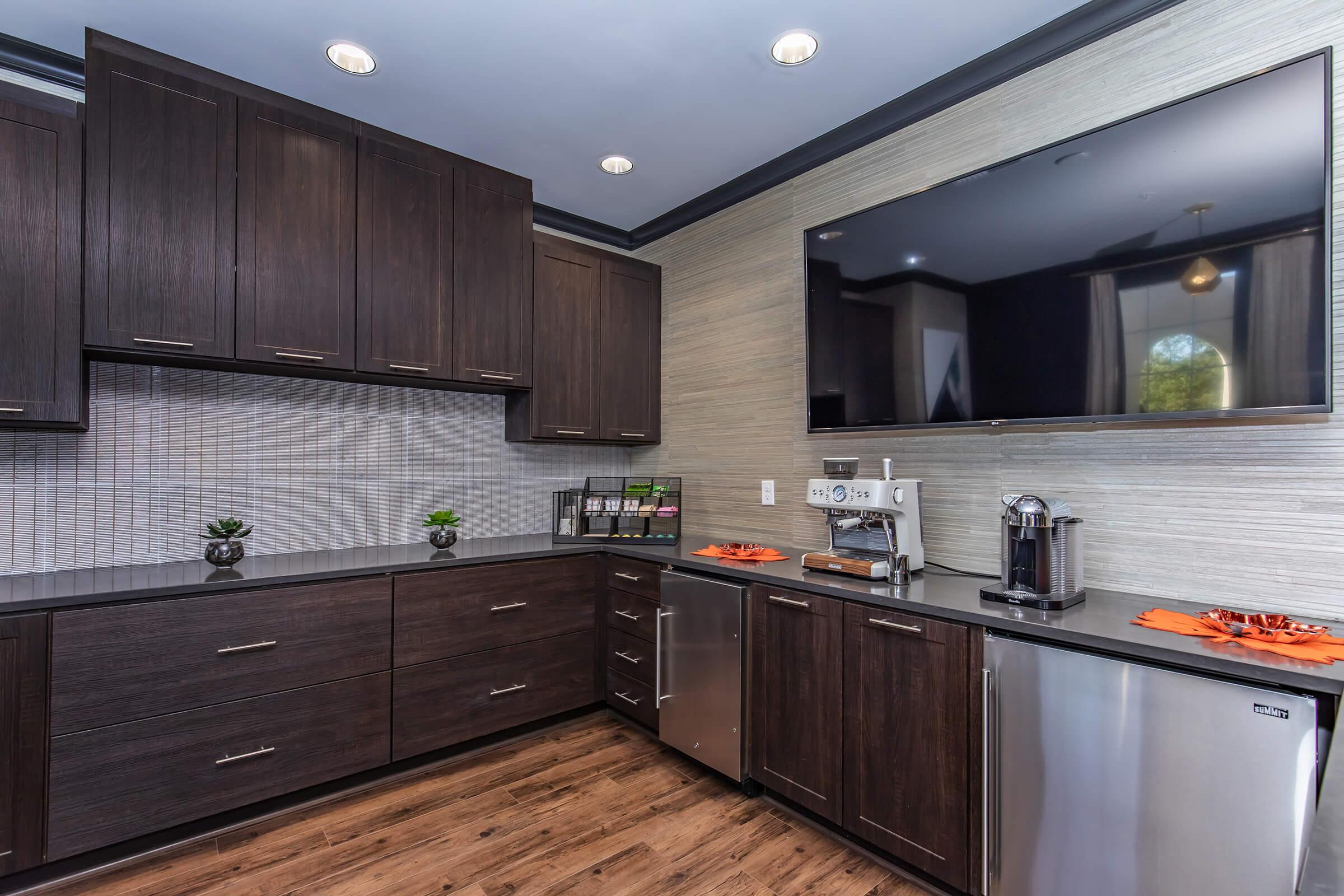 a large kitchen with stainless steel appliances and wooden cabinets