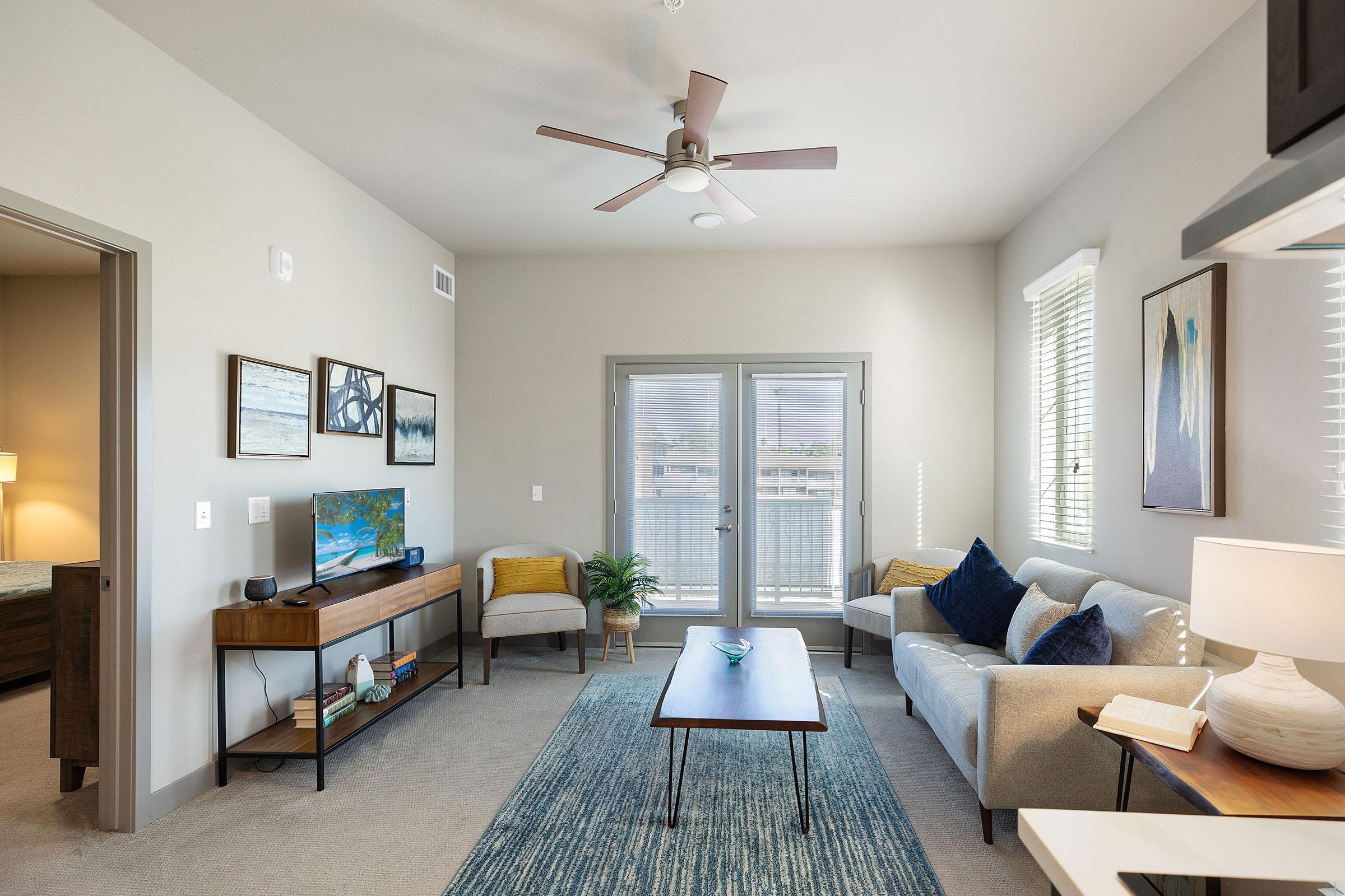 a living room filled with furniture and a flat screen tv