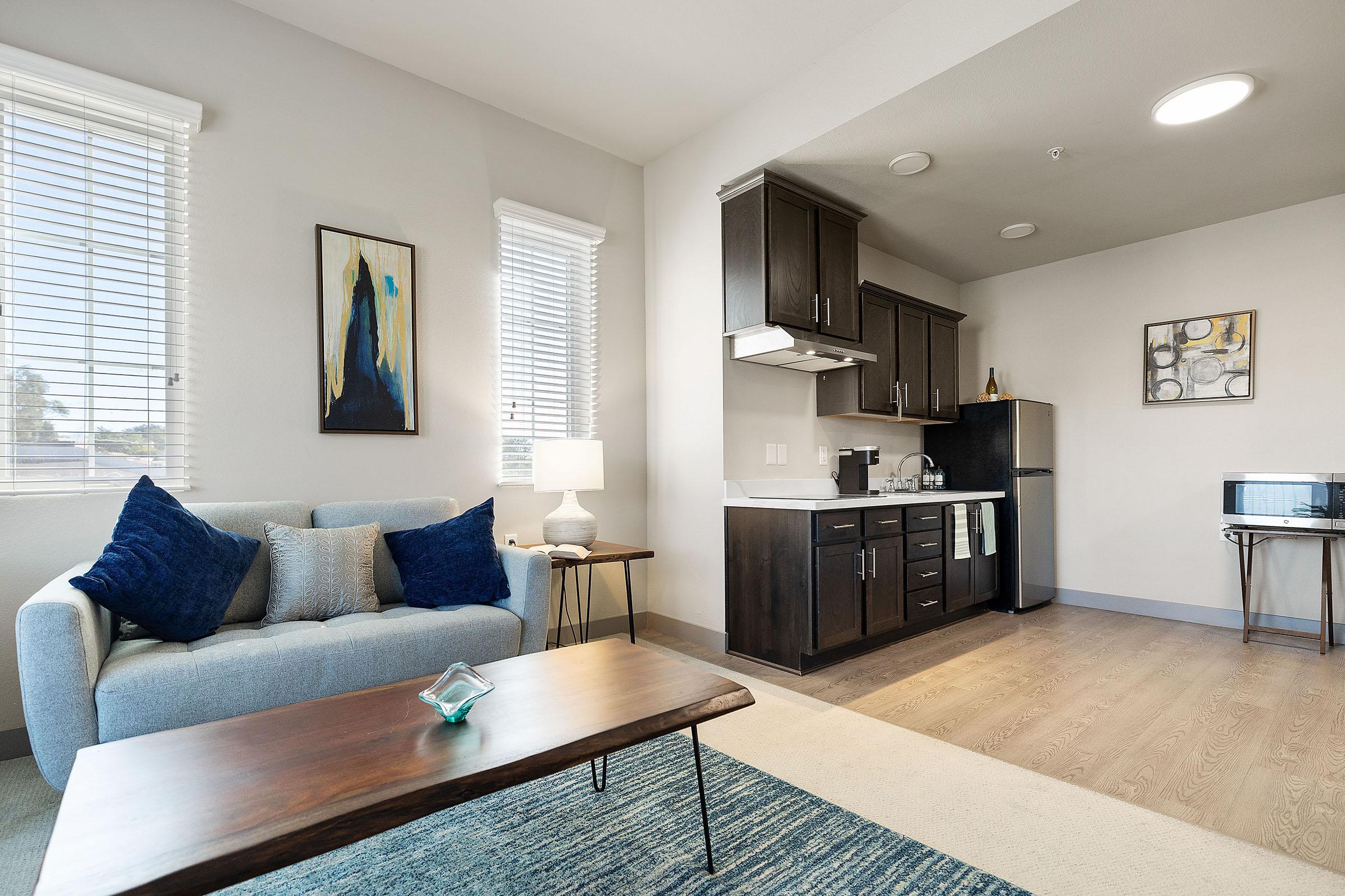 a living room filled with furniture and a large window