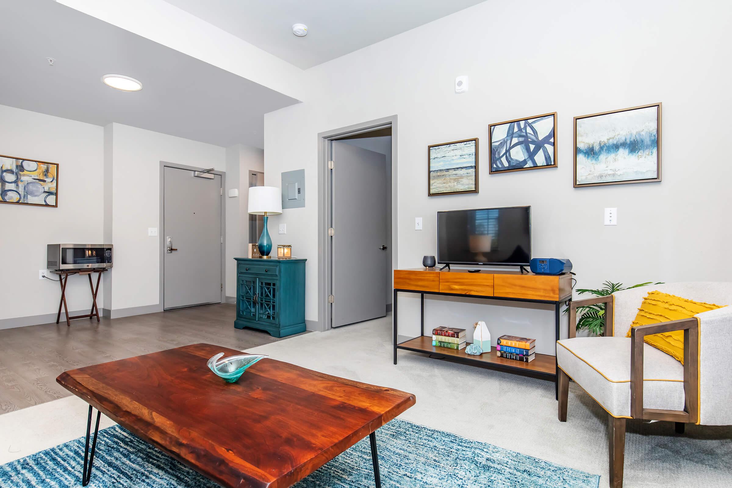 a living room filled with furniture on top of a wooden floor