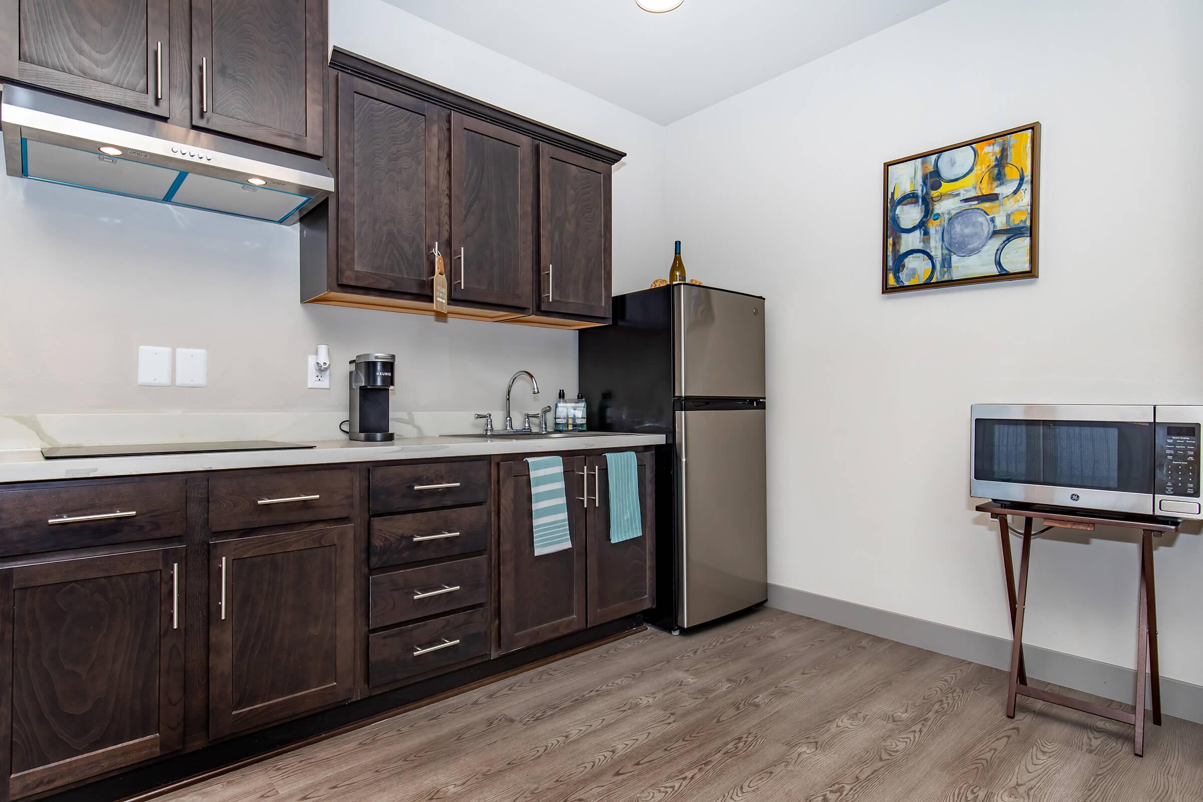 a large kitchen with stainless steel appliances and wooden cabinets