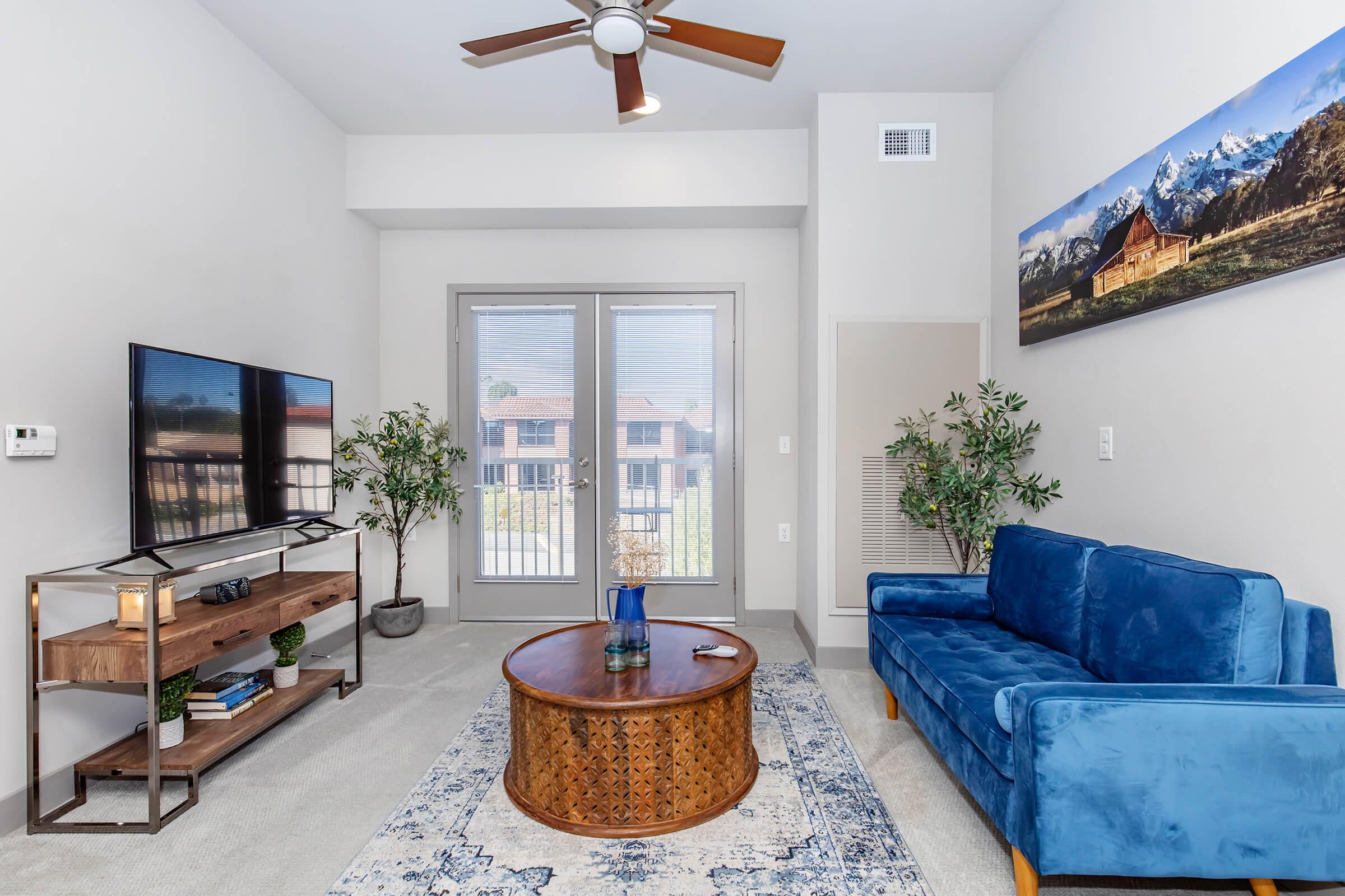 a living room filled with furniture and a large window