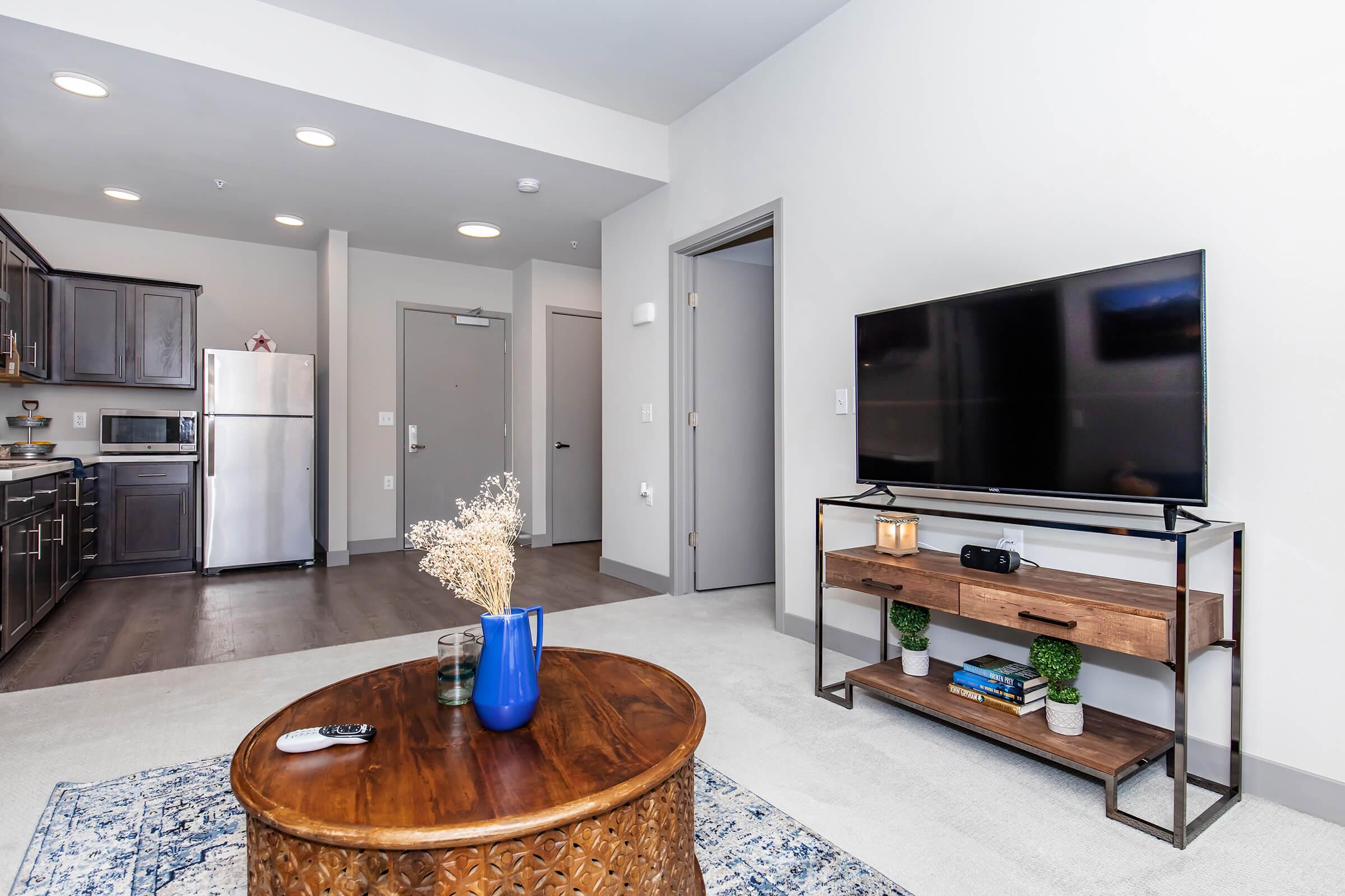 a living room filled with furniture and a flat screen tv