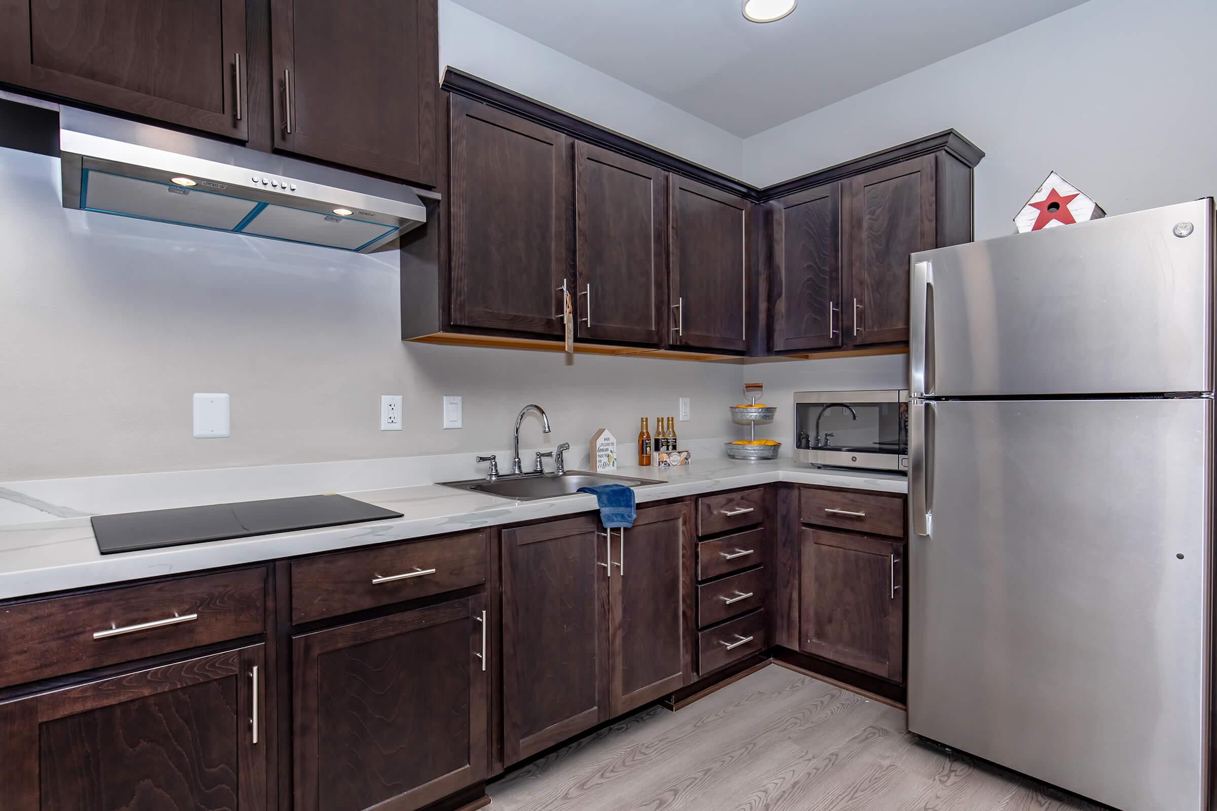 a kitchen with stainless steel appliances and wooden cabinets