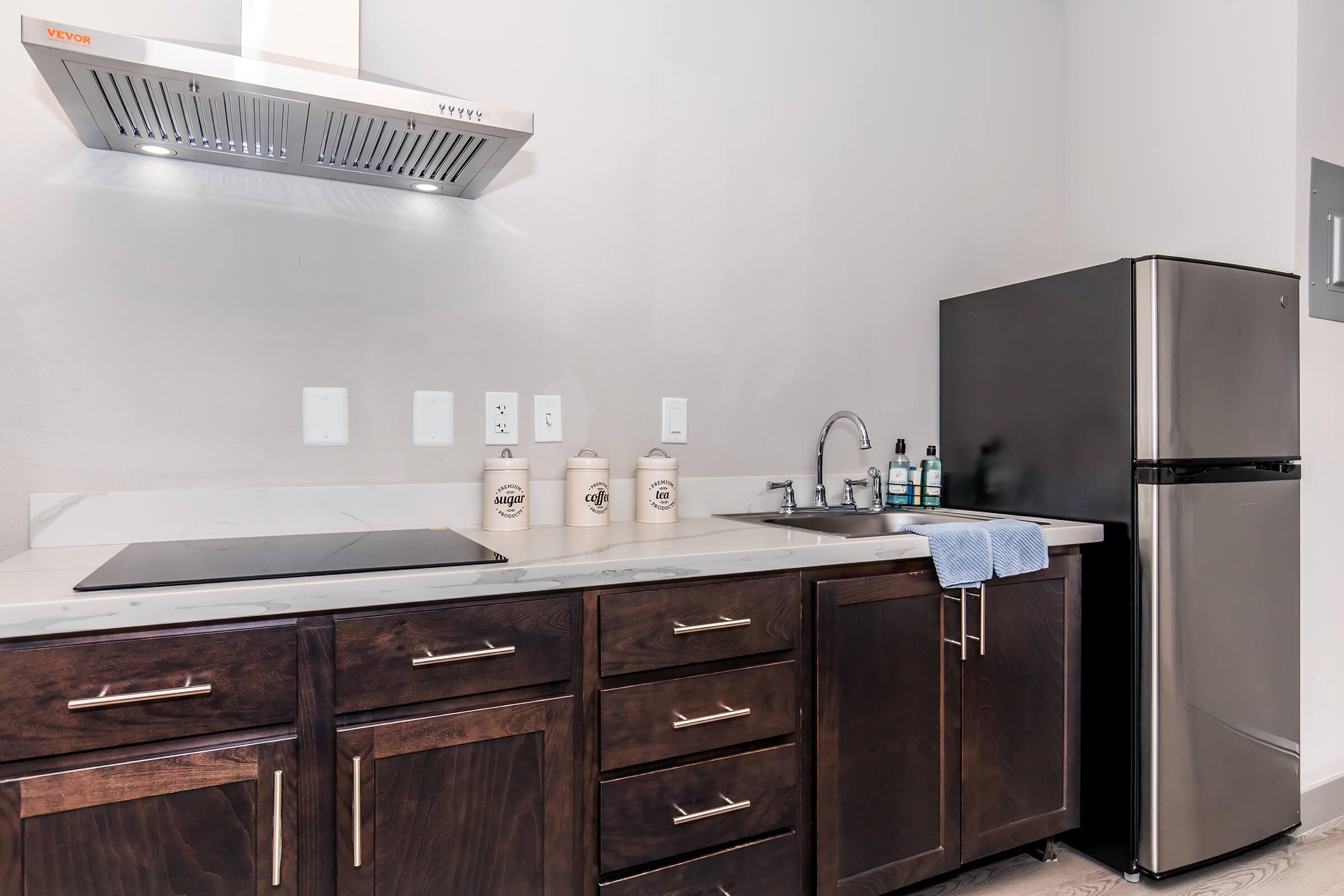 a kitchen with a sink and a refrigerator