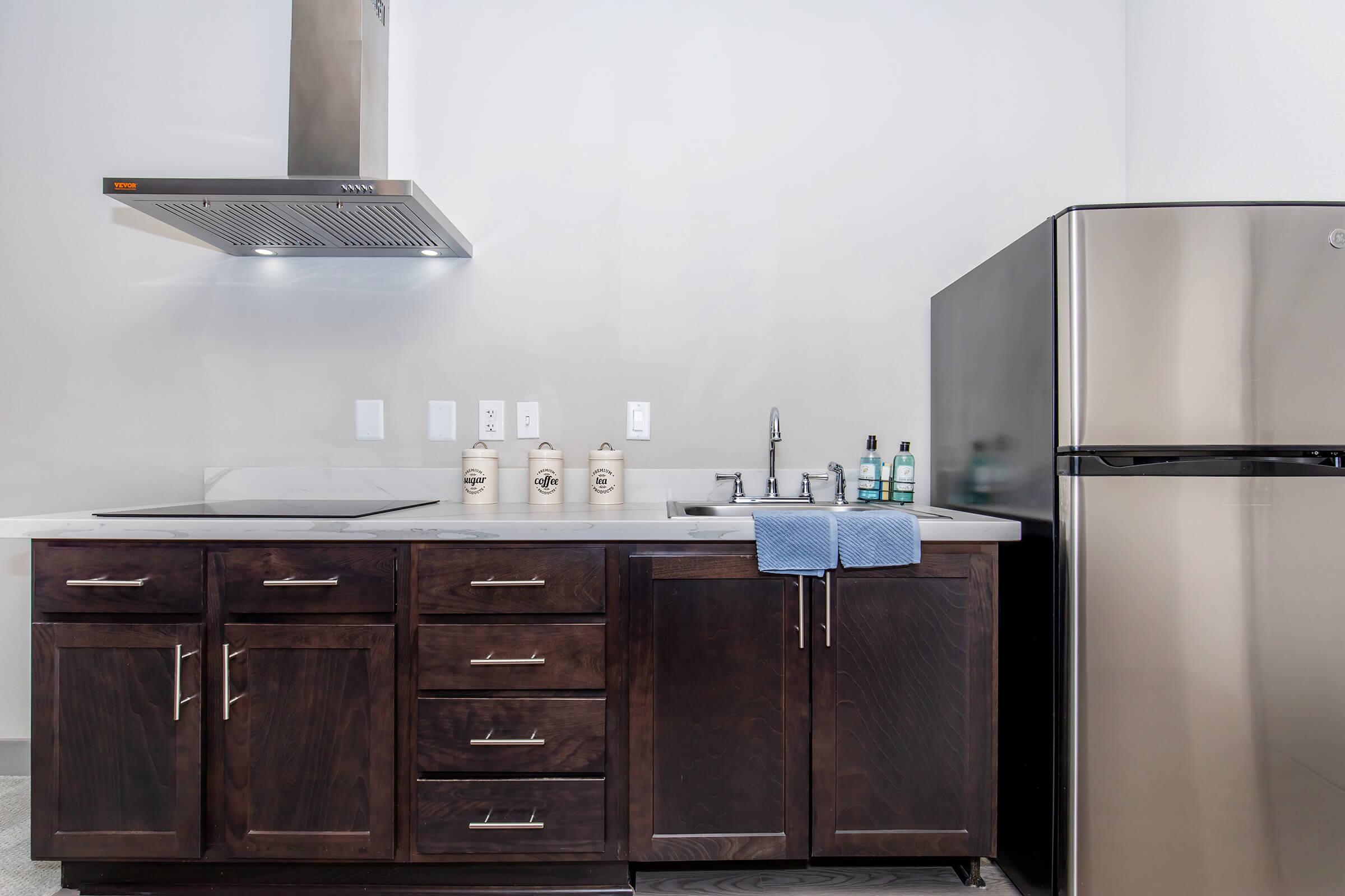 a kitchen with a sink and a refrigerator