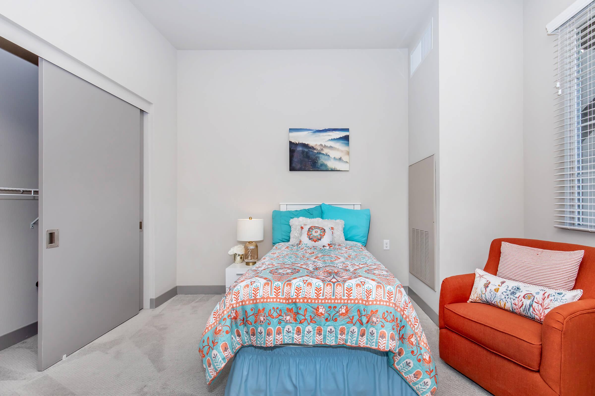 a bedroom with a view of a living room