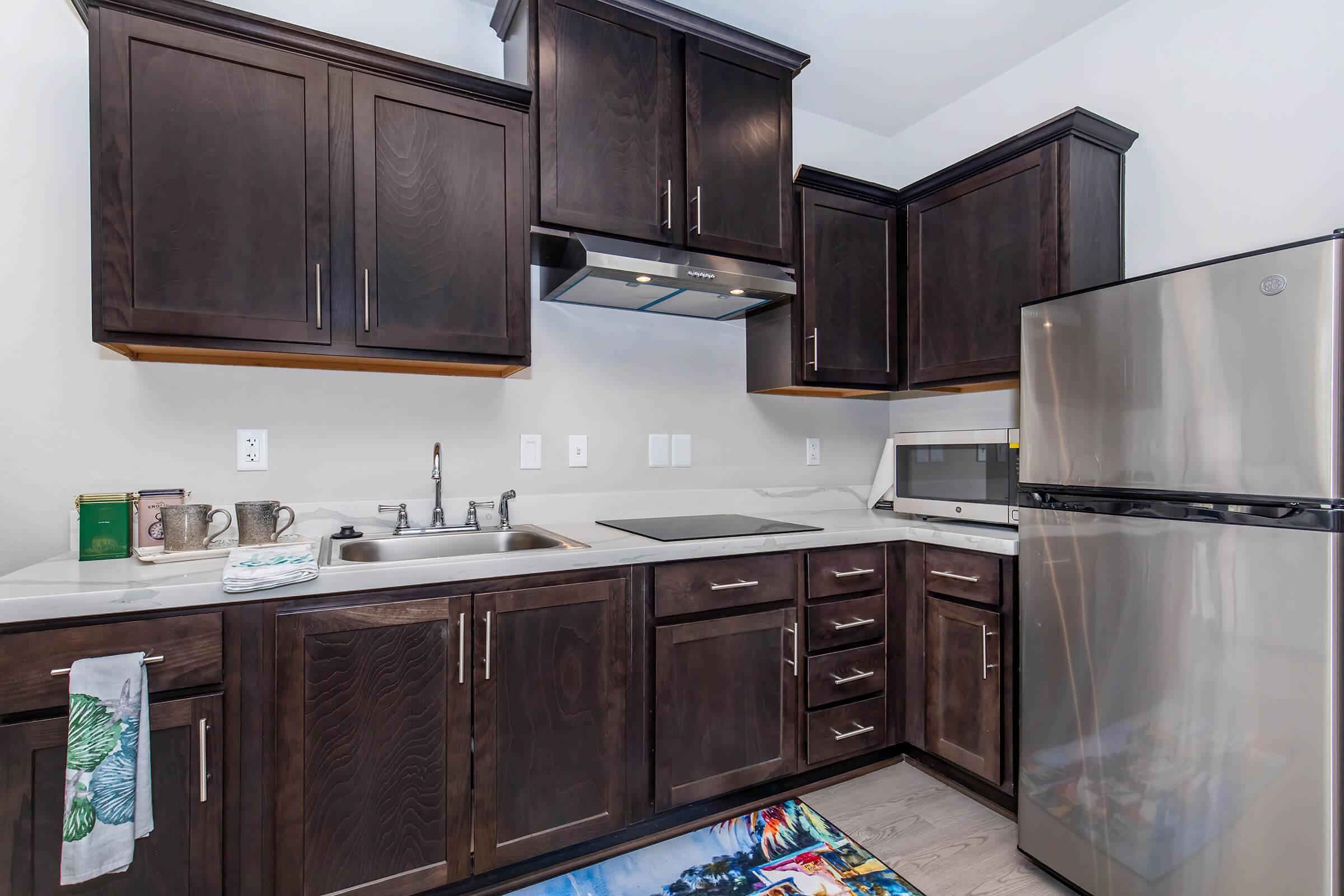 a kitchen with stainless steel appliances and wooden cabinets