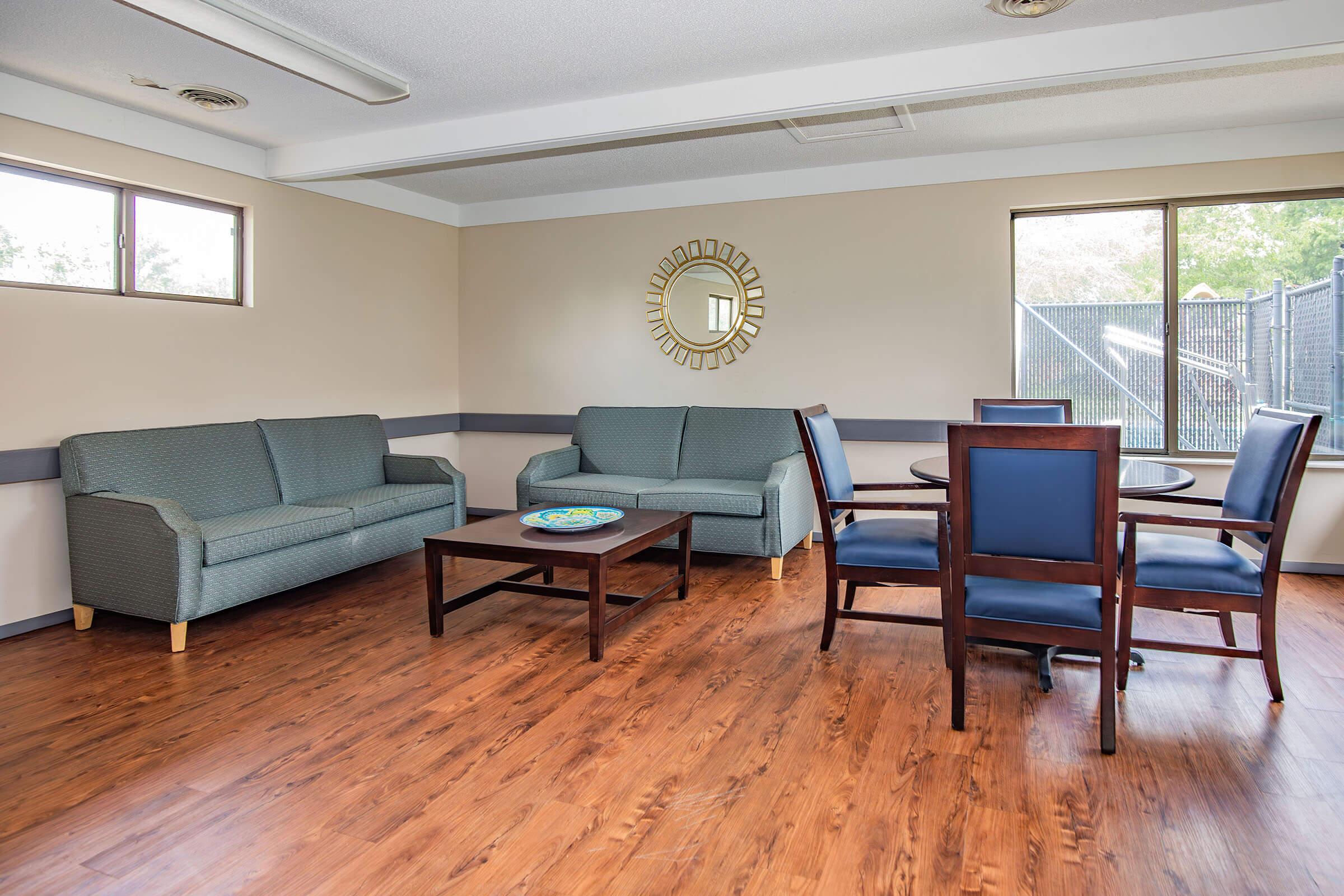 a living room filled with furniture and a large window