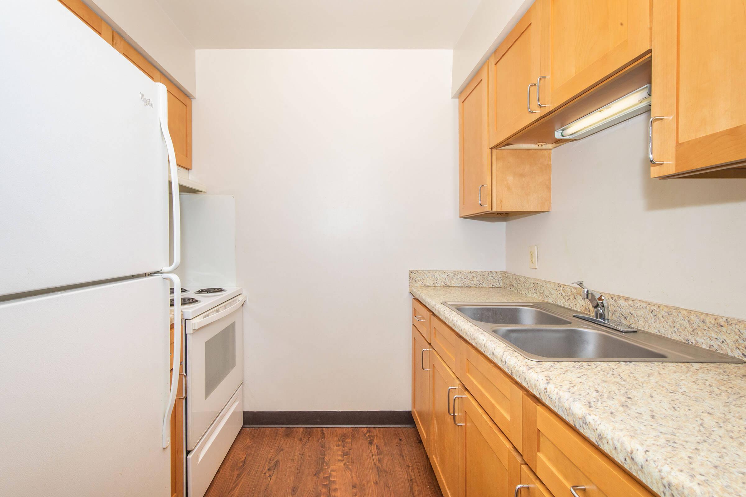 a kitchen with a sink and a refrigerator