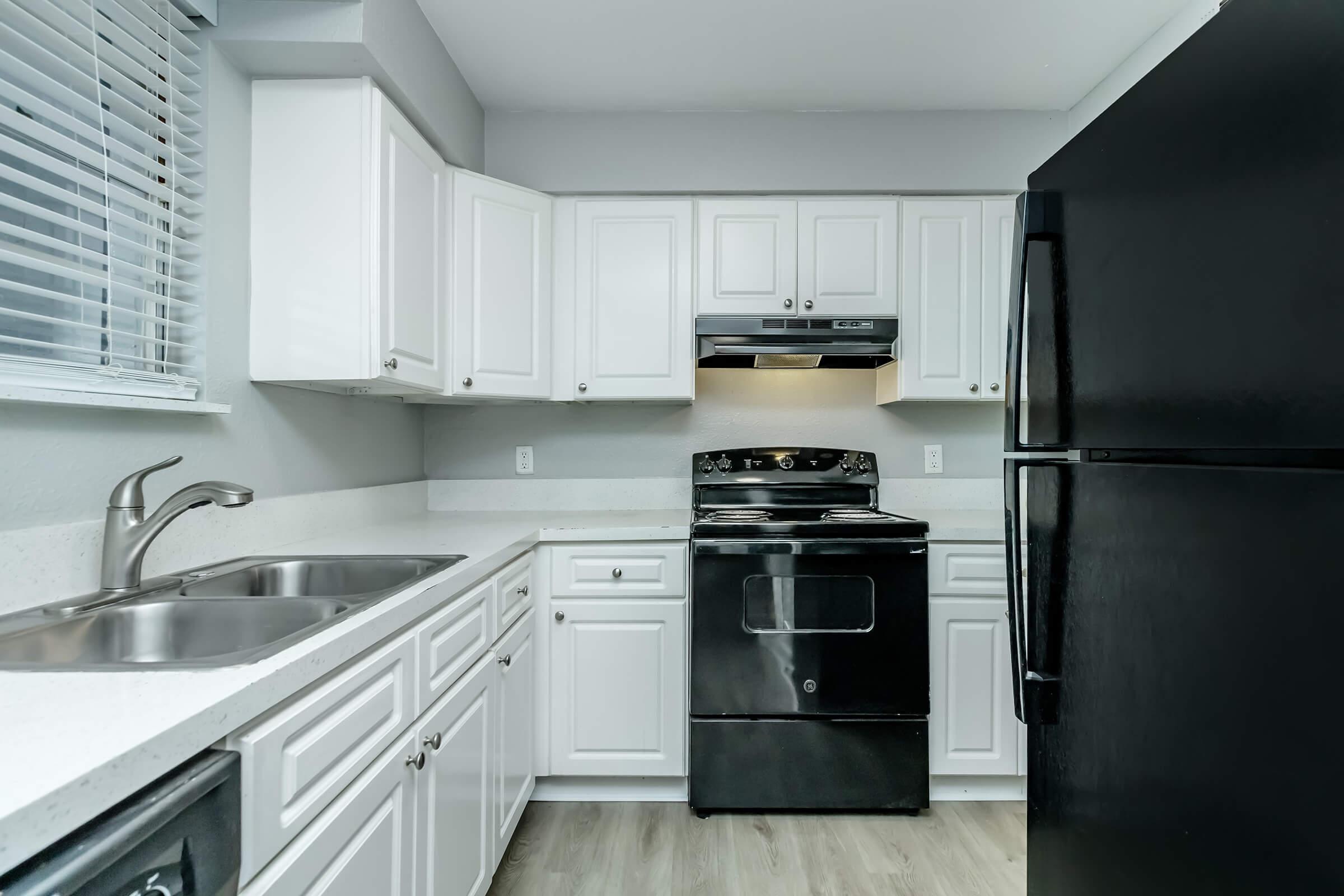 a kitchen with a stove and a refrigerator