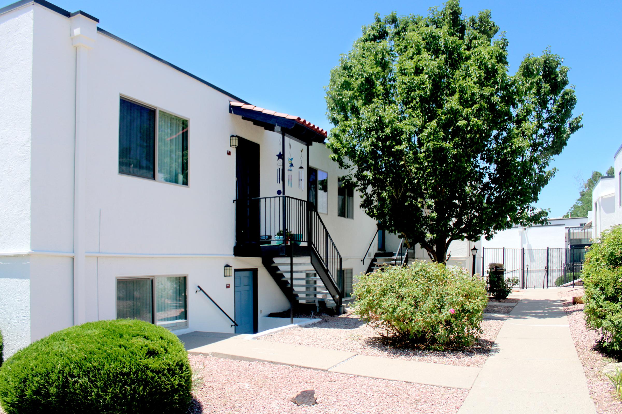 a house with bushes in front of a building