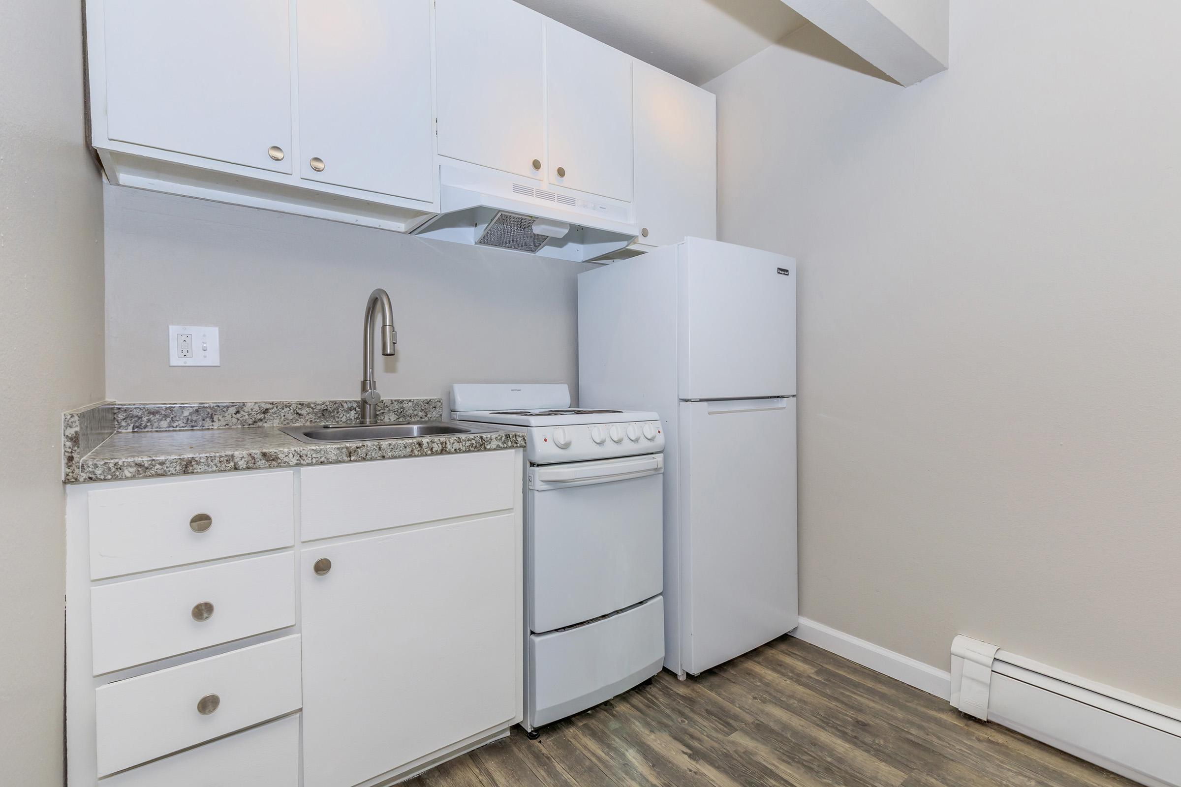 a kitchen with a sink and a refrigerator