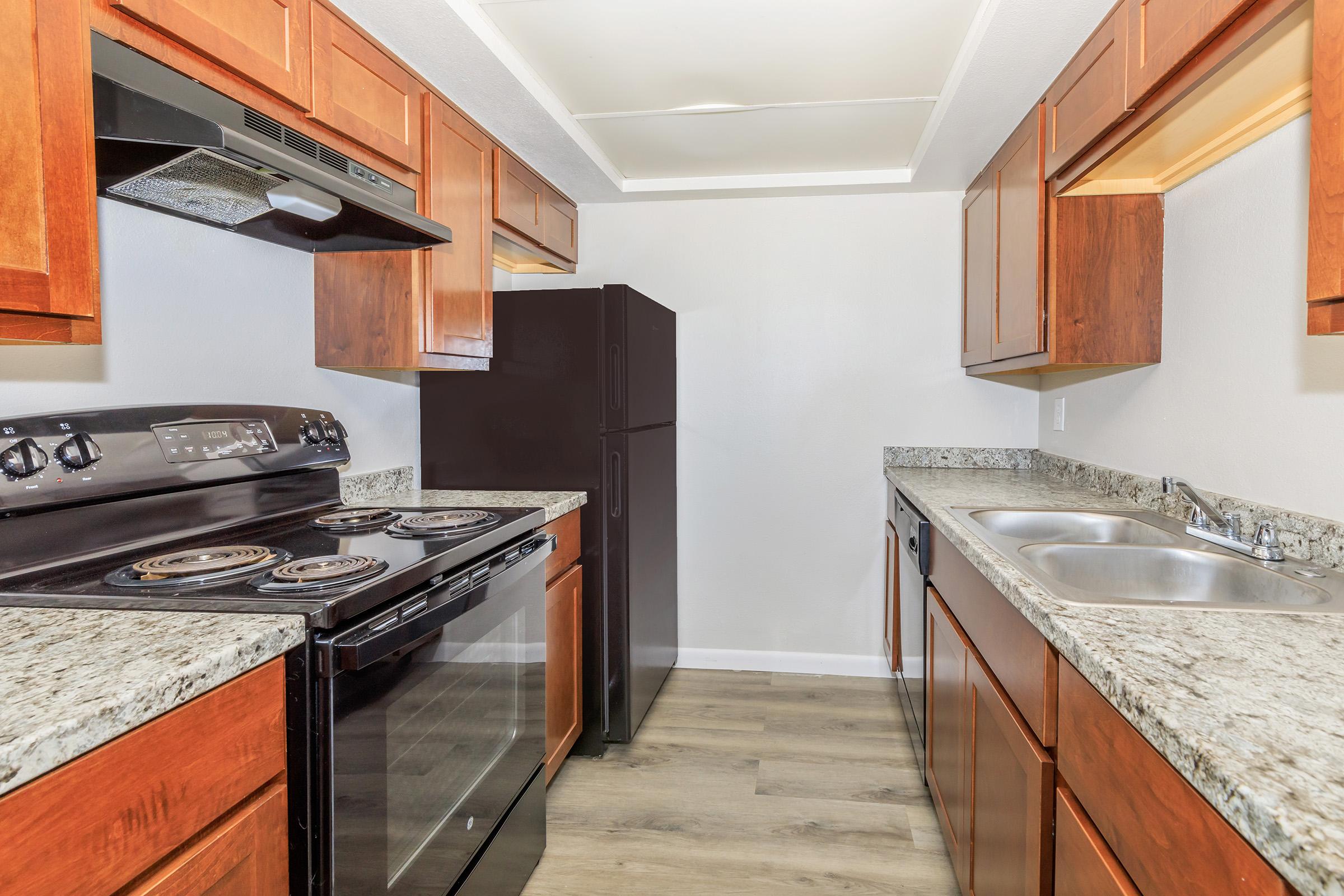 a kitchen with stainless steel appliances and wooden cabinets