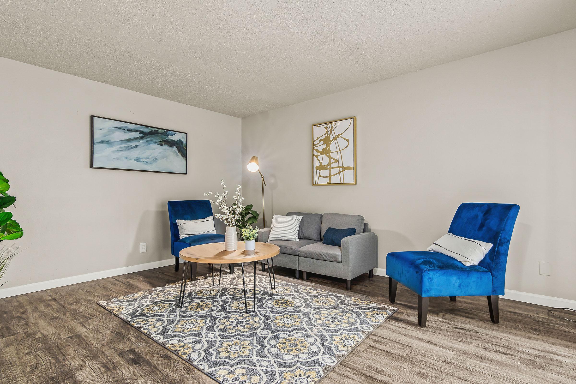 a living room filled with furniture and a rug