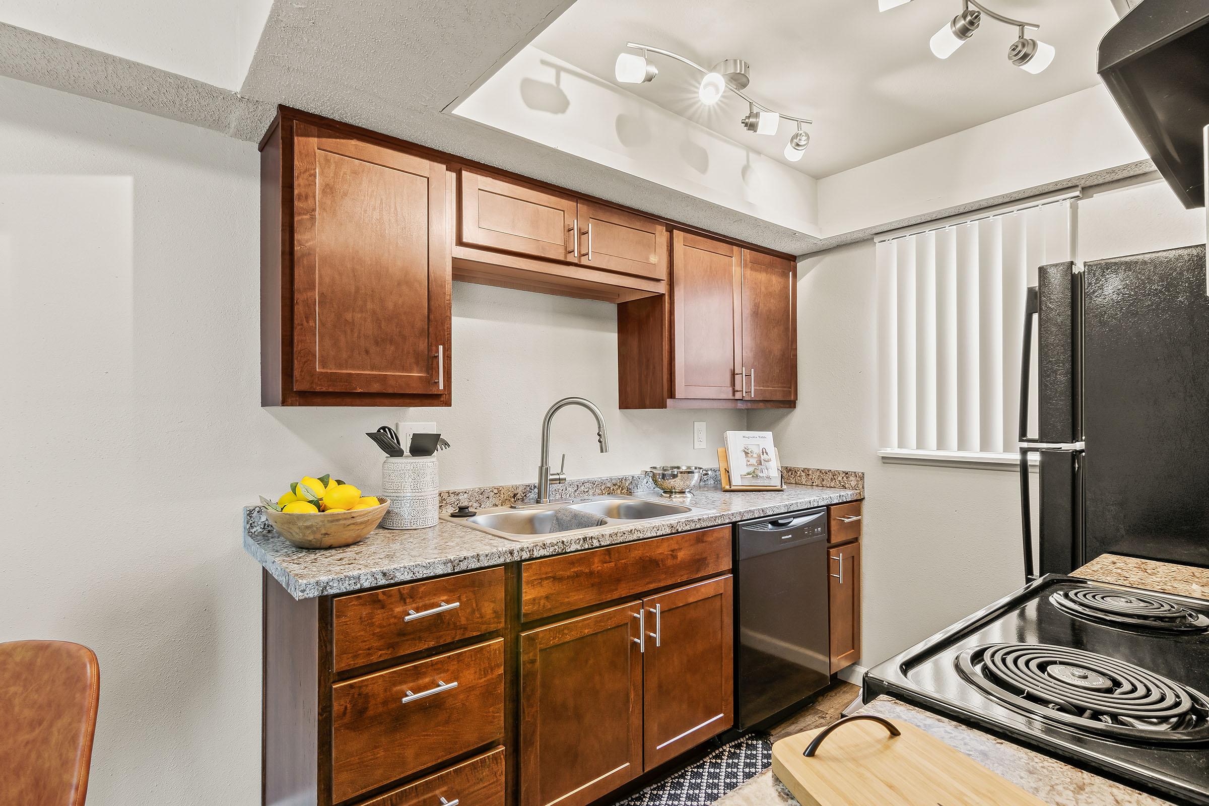 a kitchen with a sink and a mirror