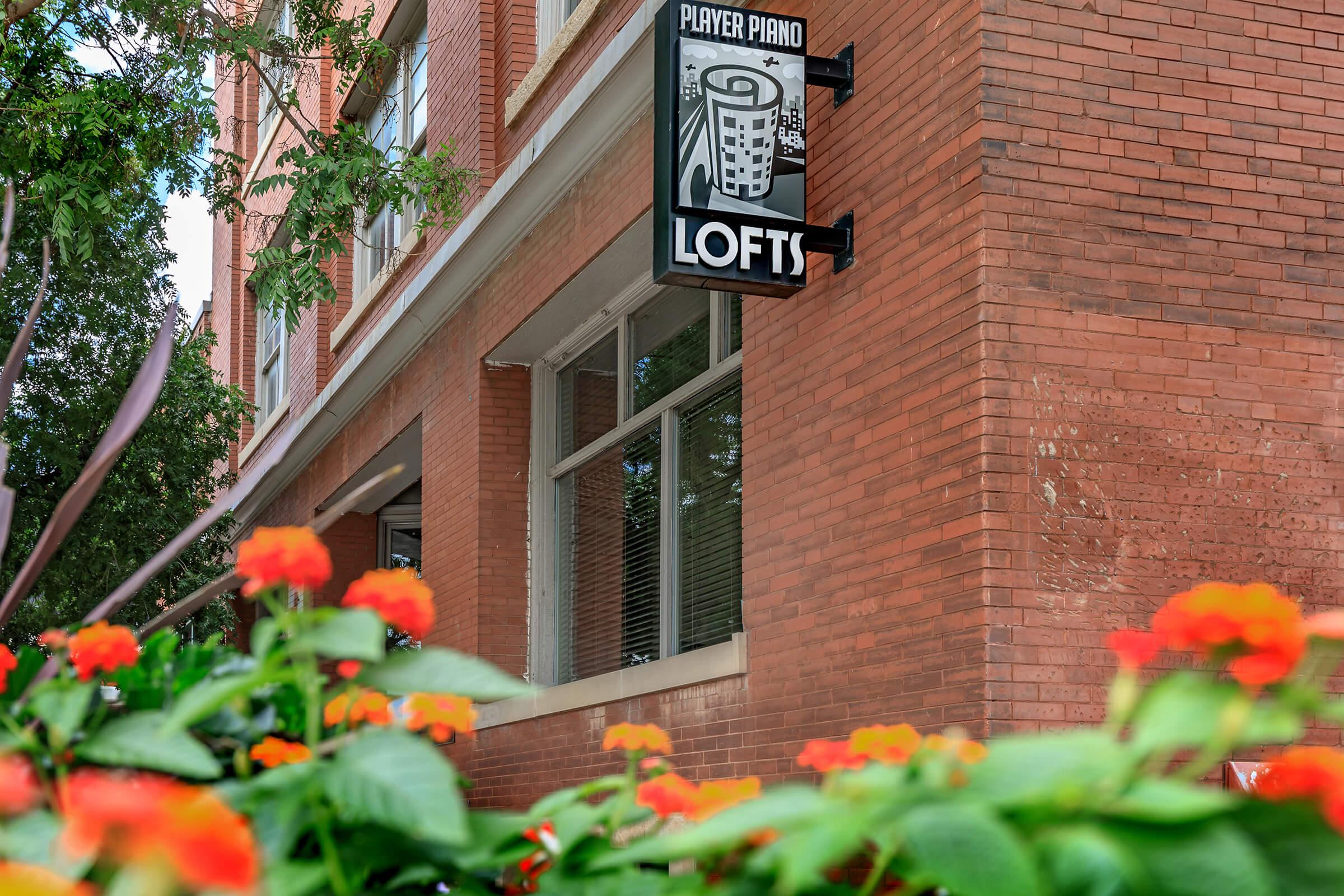 an orange sign on a brick building