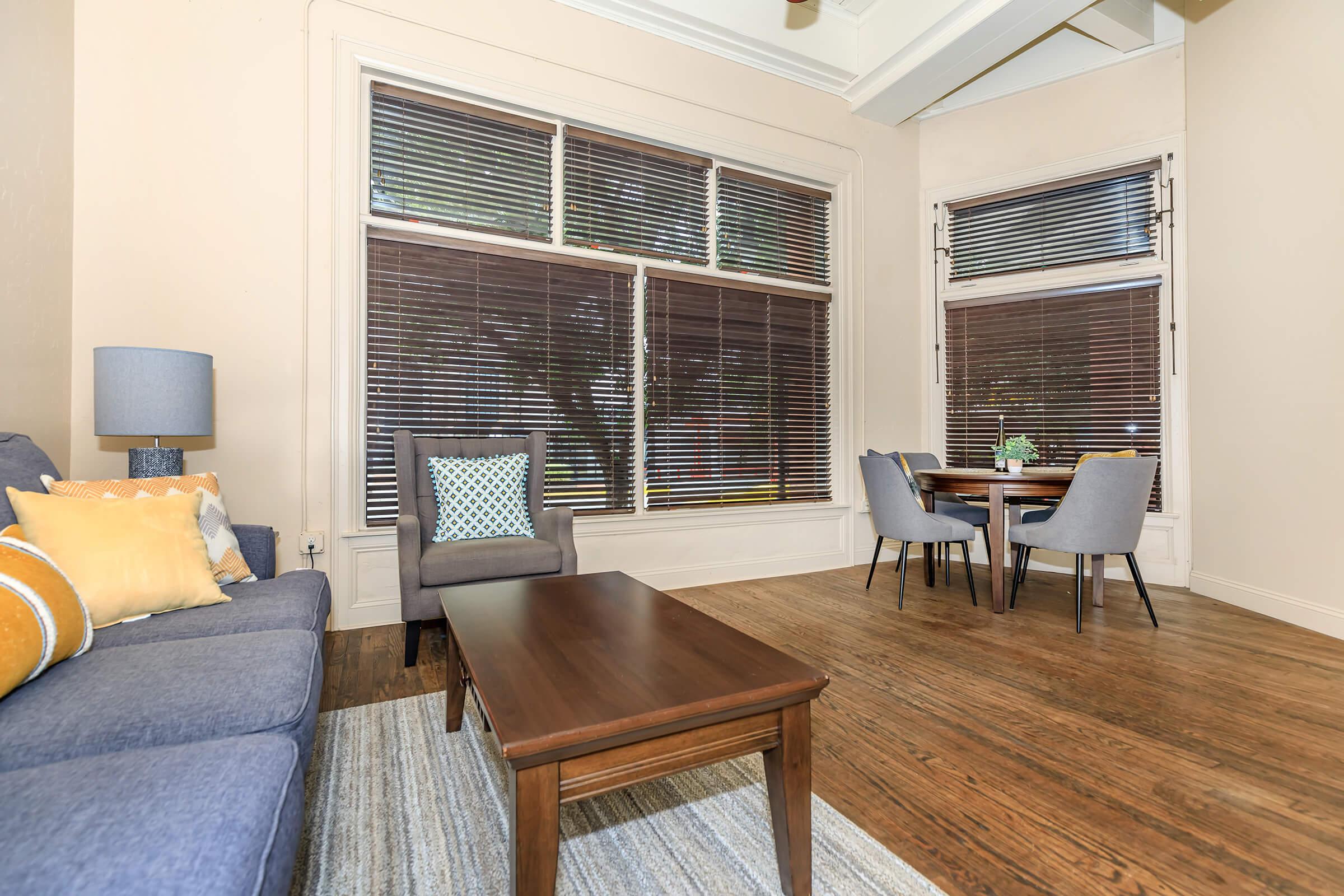 a living room filled with furniture and a large window