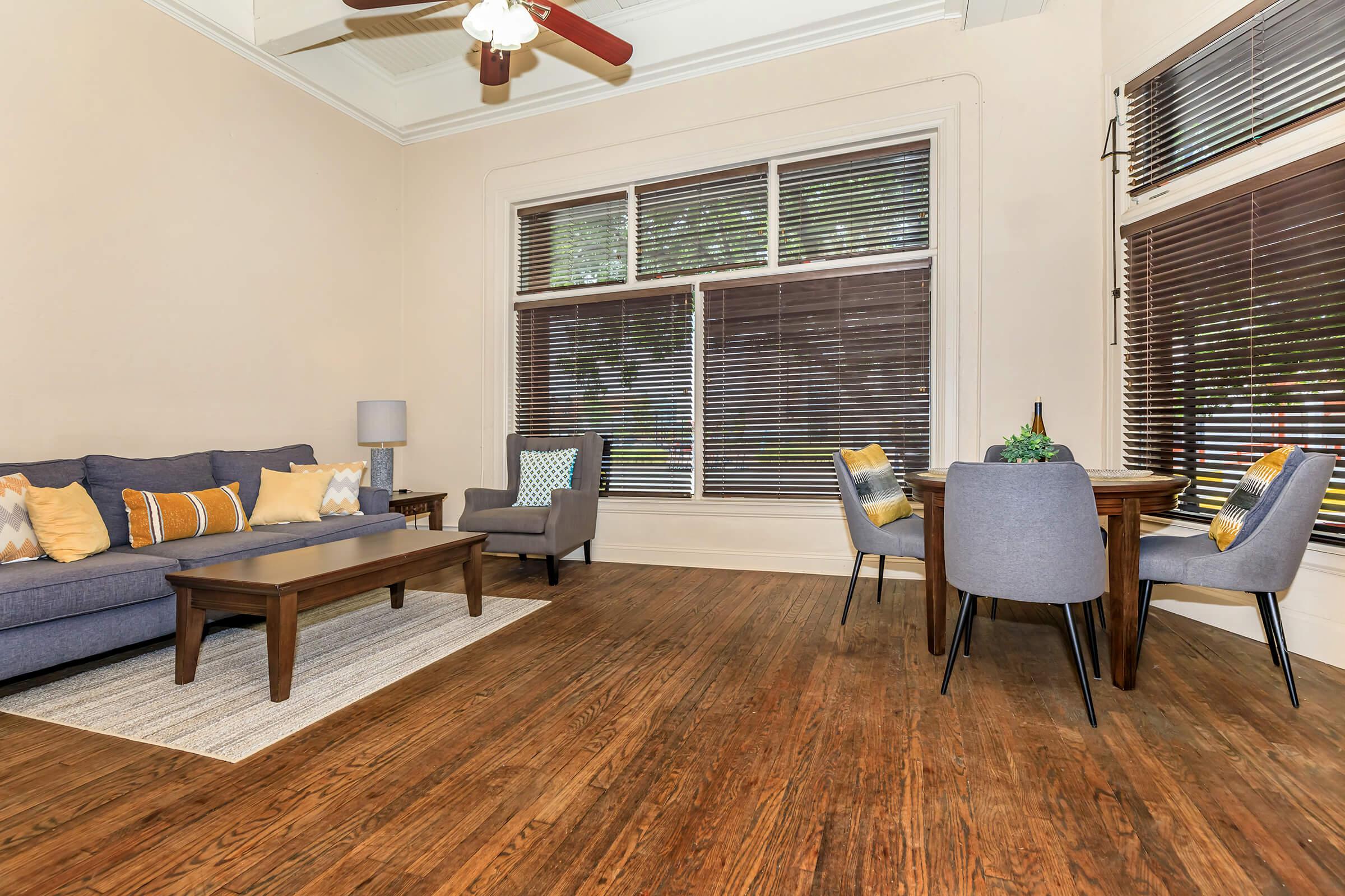 a living room filled with furniture and a large window