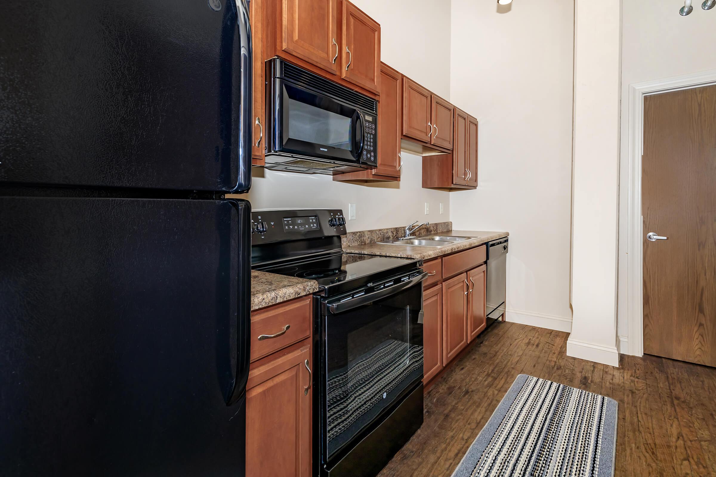 a kitchen with stainless steel appliances and wooden cabinets