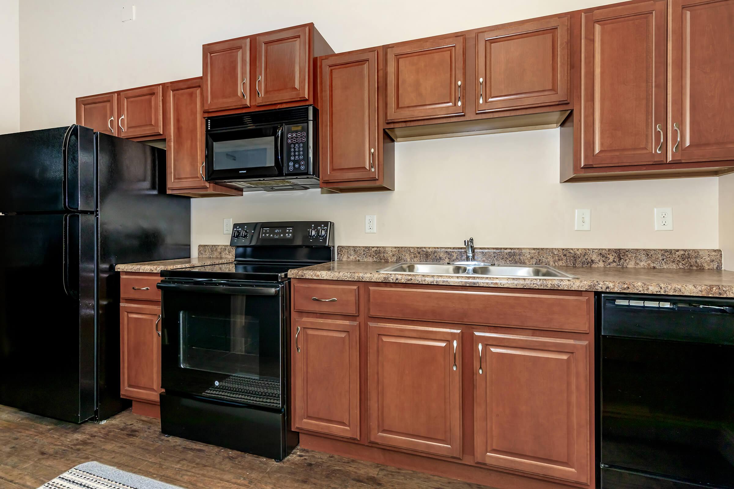 a kitchen with stainless steel appliances and wooden cabinets