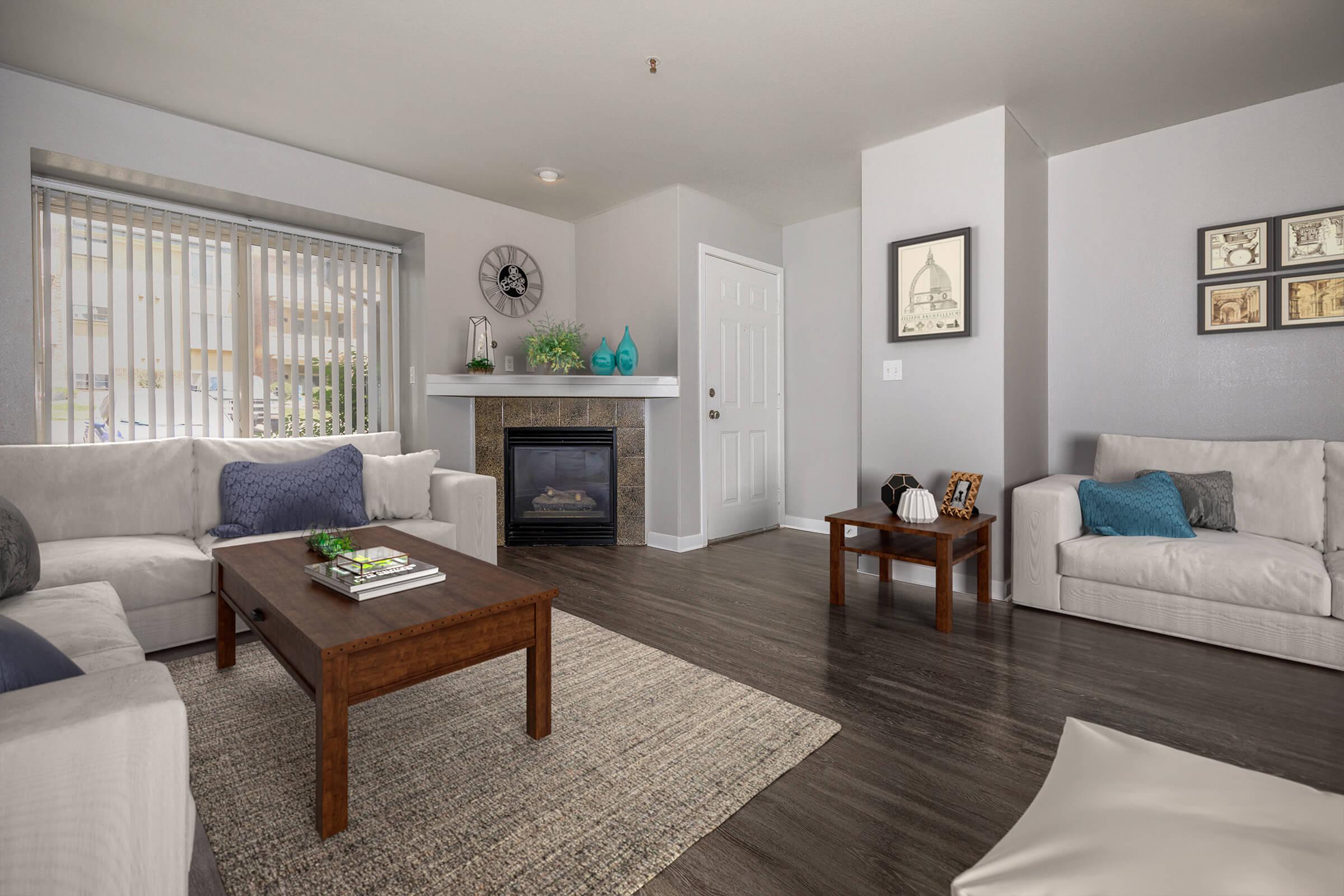 a living room filled with furniture and a large window