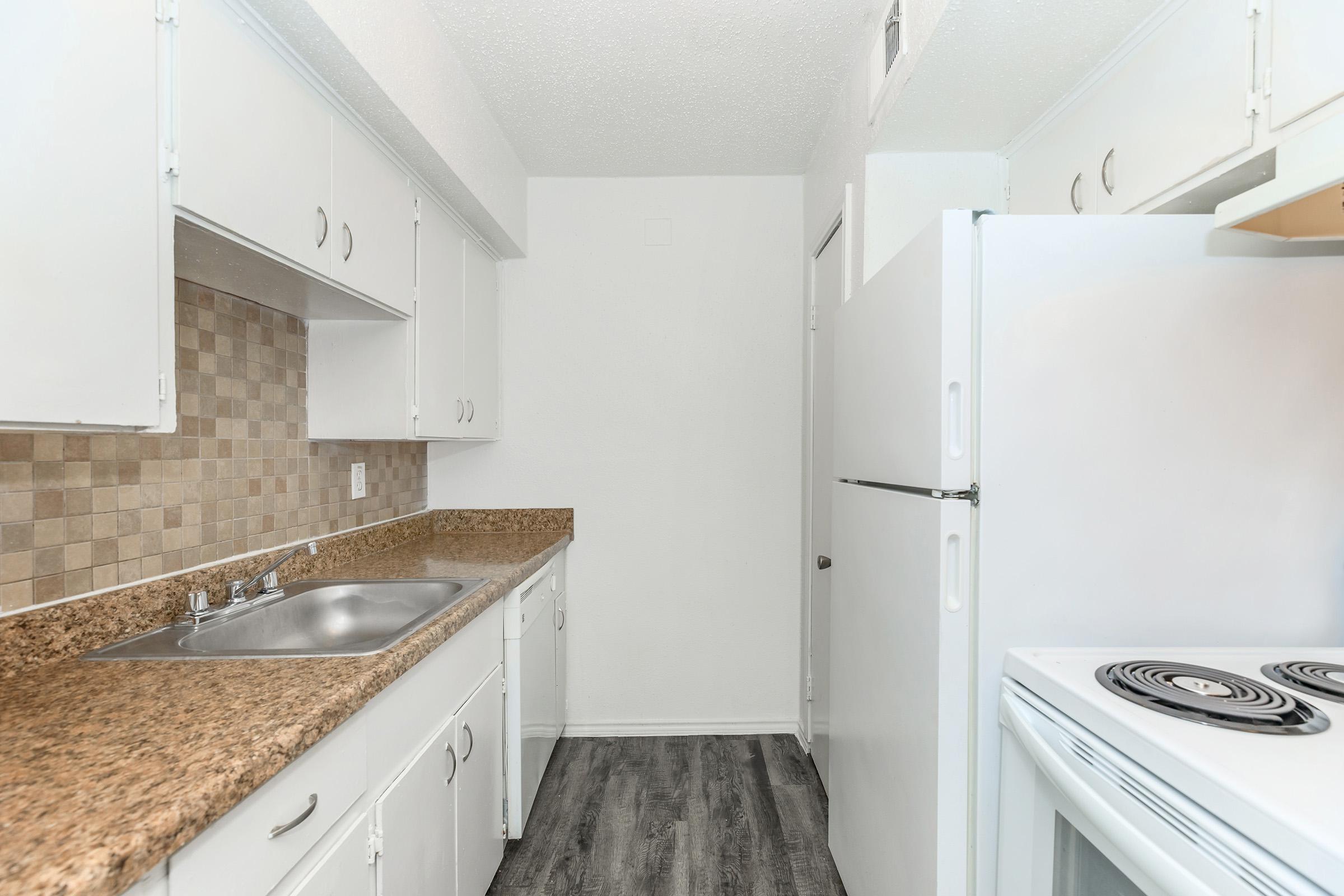 a kitchen with a sink and a refrigerator