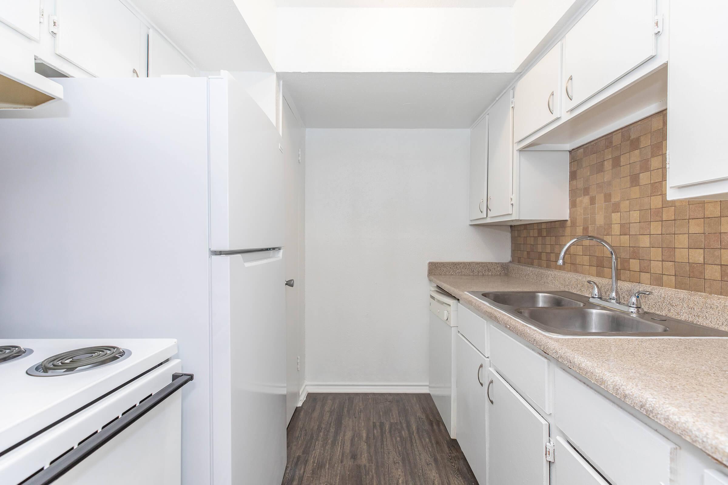 a kitchen with a sink and a refrigerator