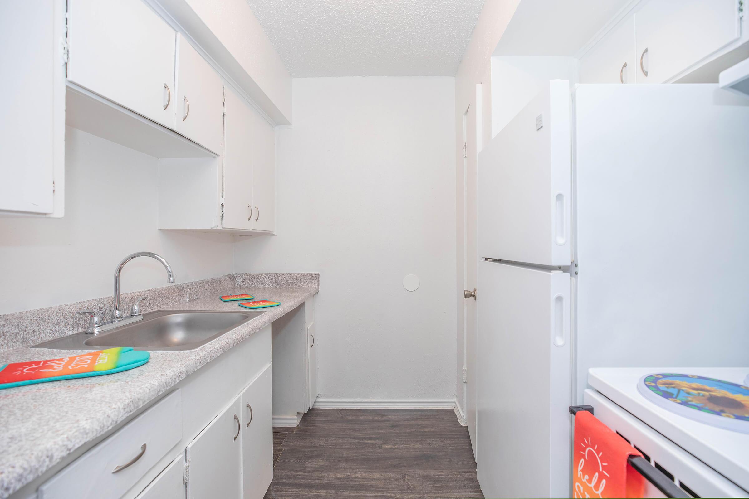 a kitchen with a sink and a refrigerator