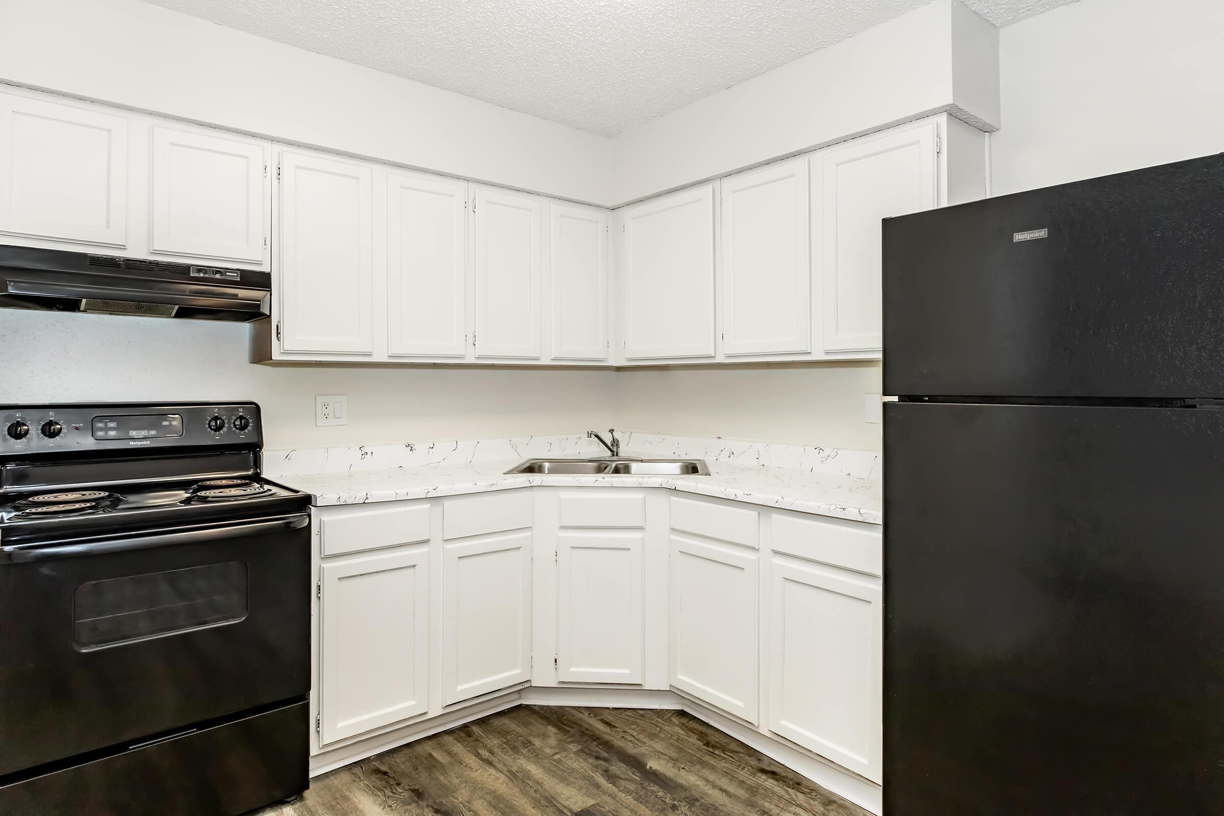 a kitchen with a stove and a refrigerator