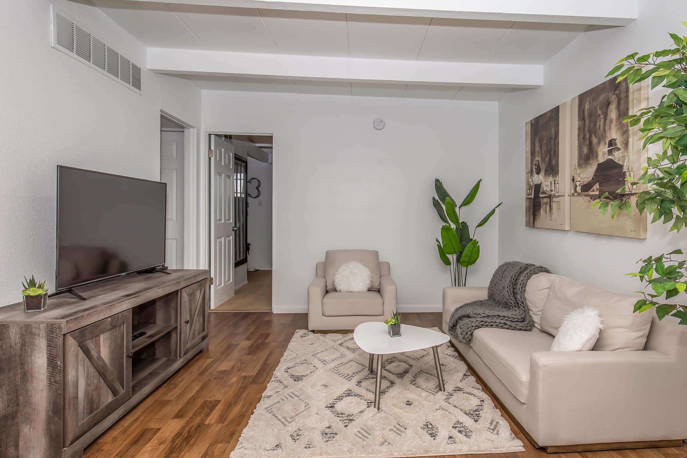 a living room filled with furniture and a large window