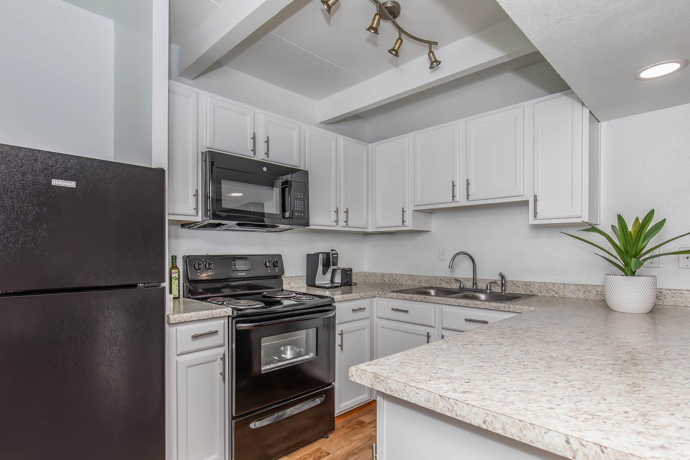 a stove top oven sitting inside of a kitchen