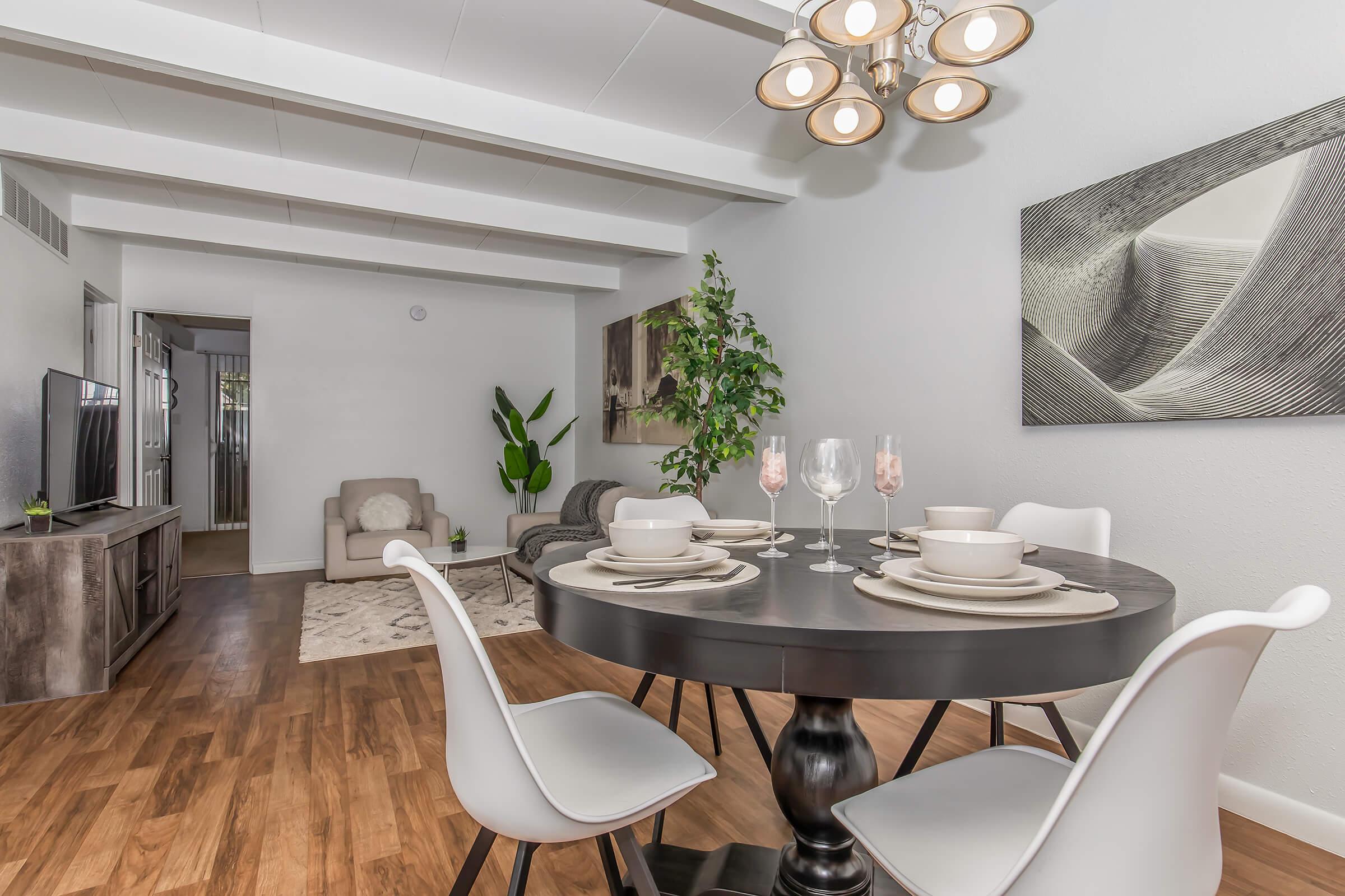 a room filled with furniture and vase of flowers on a table