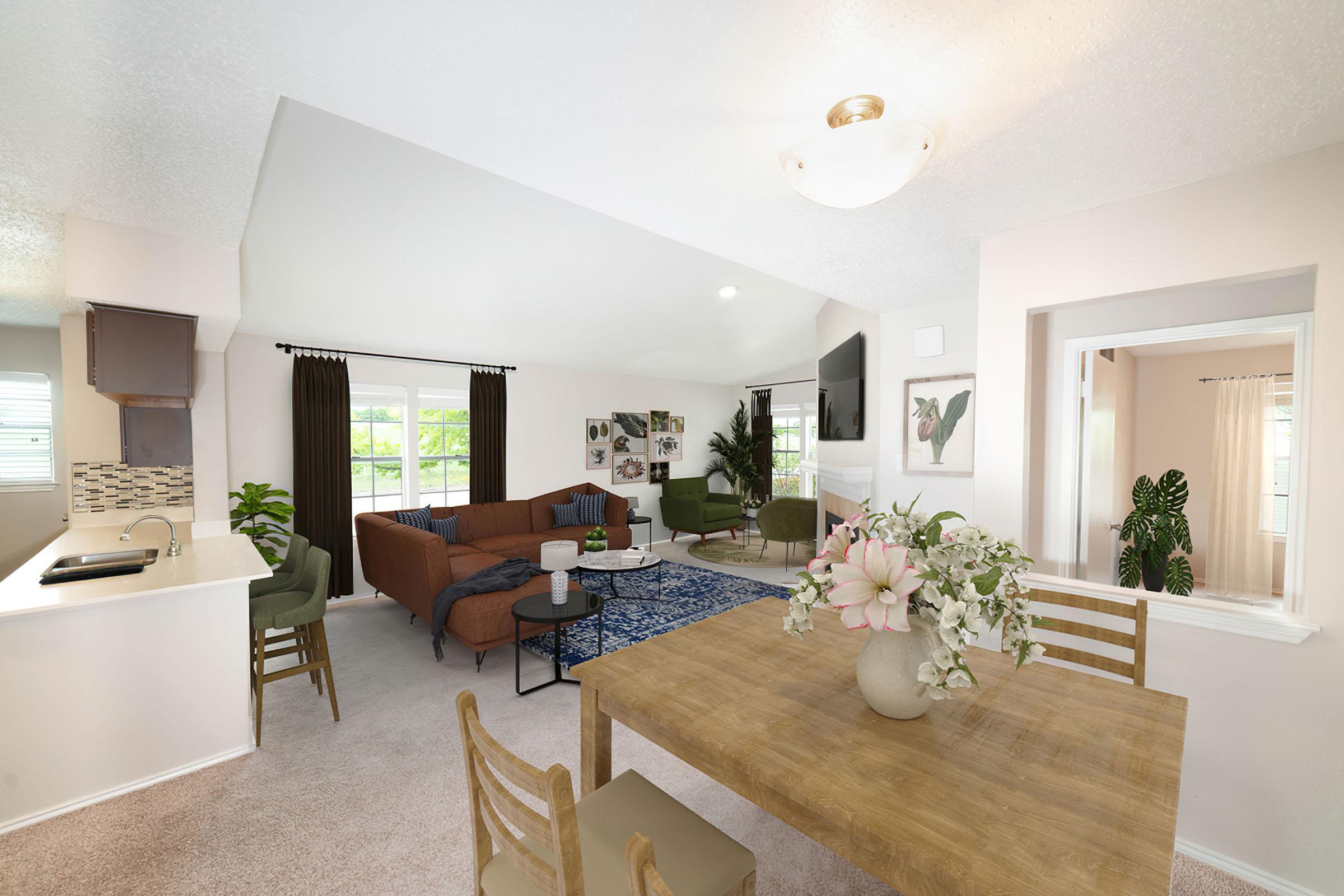 a living room filled with furniture and vase of flowers on a table