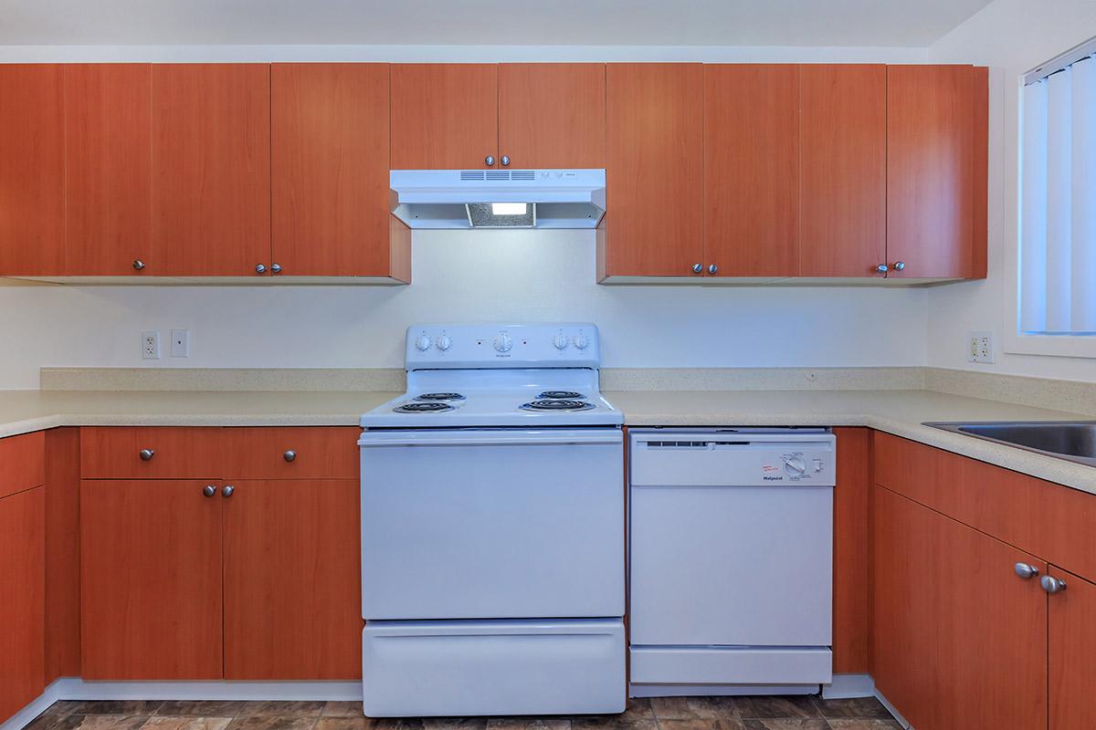 a kitchen with a stove and a refrigerator