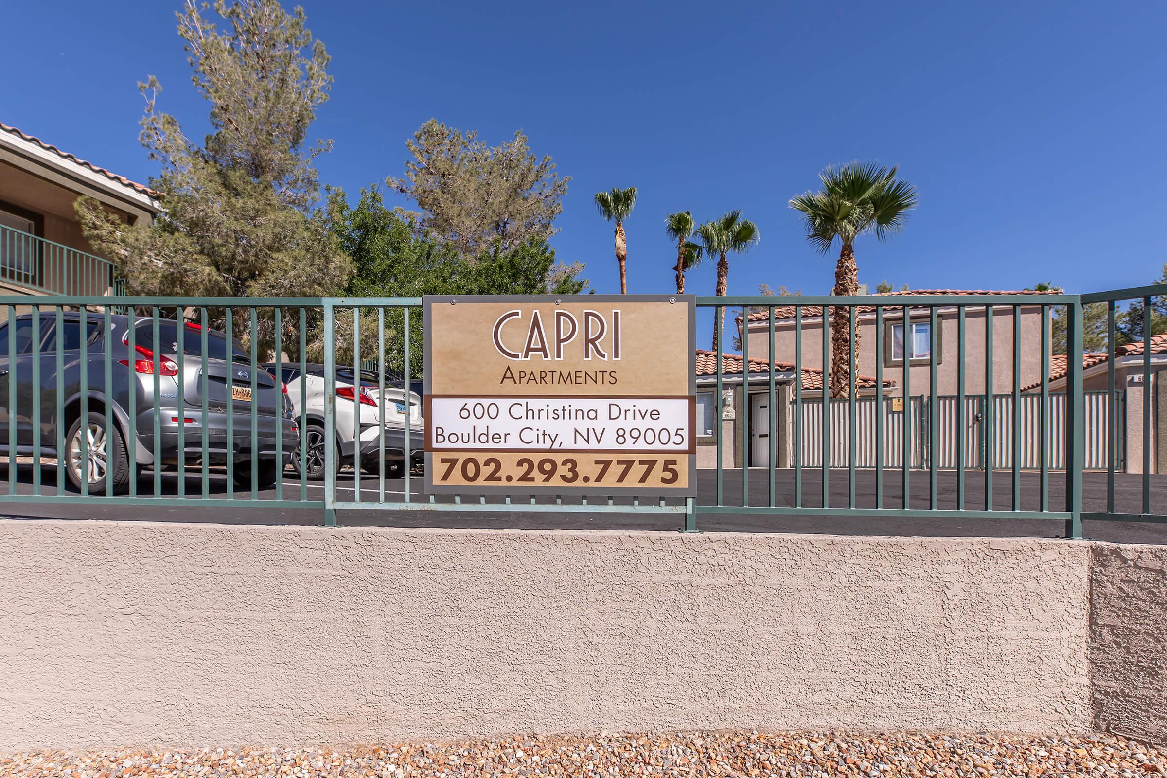 a sign in front of a fence