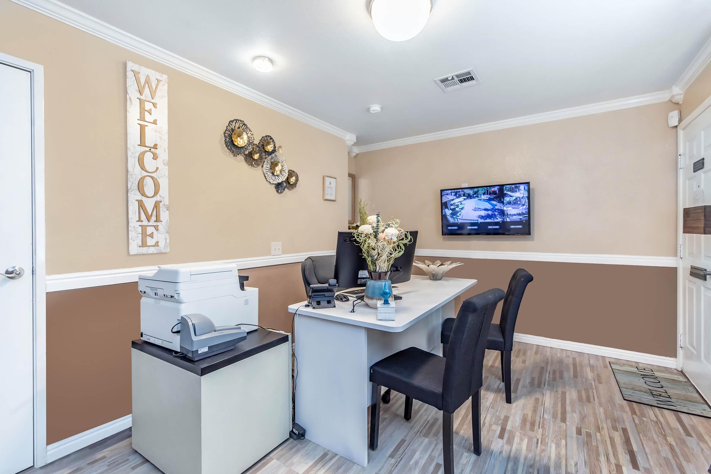 a bedroom with a desk and chair in a room