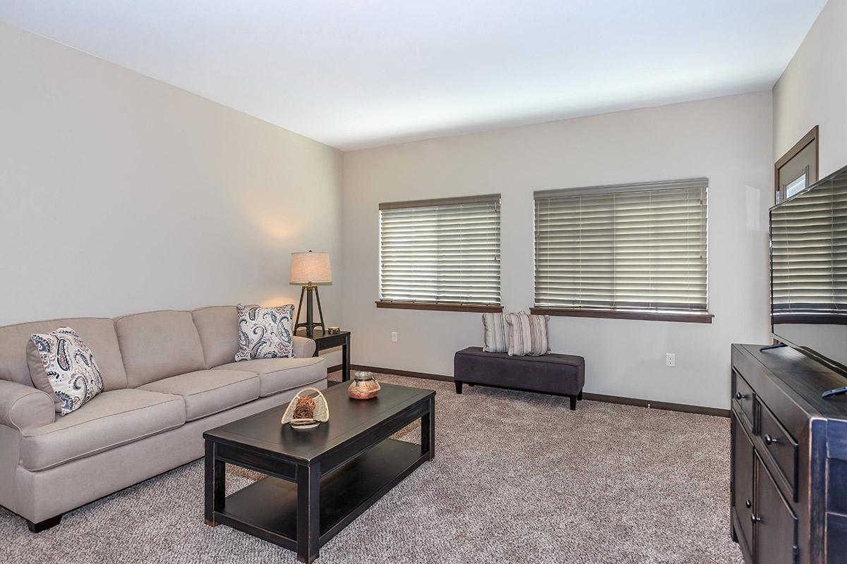 a living room filled with furniture and a large window