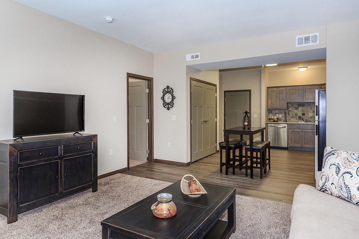 a living room filled with furniture and a flat screen tv