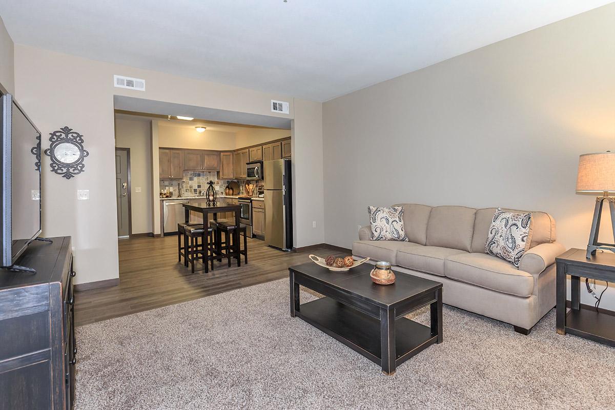 a living room filled with furniture and a flat screen tv